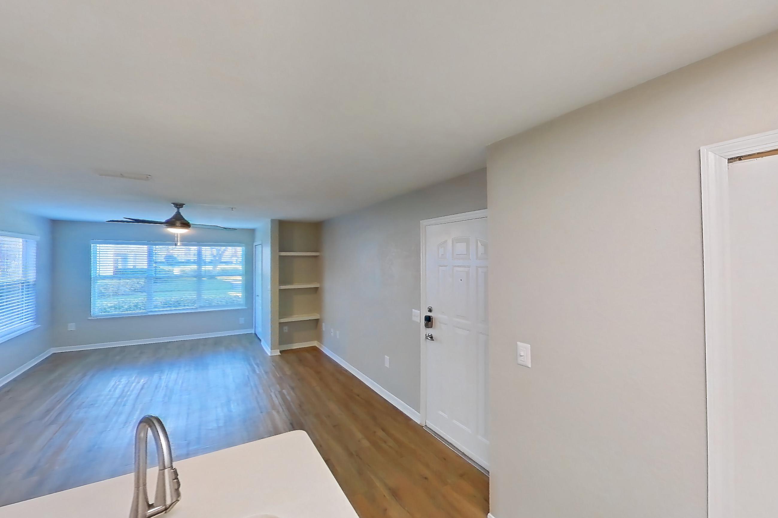Kitchen with dishwasher, electric range, light countertops, light wood-finish flooring, microwave, oven/range, refrigerator, and stainless steel appliances, Apartment 15-102 at Boot Ranch