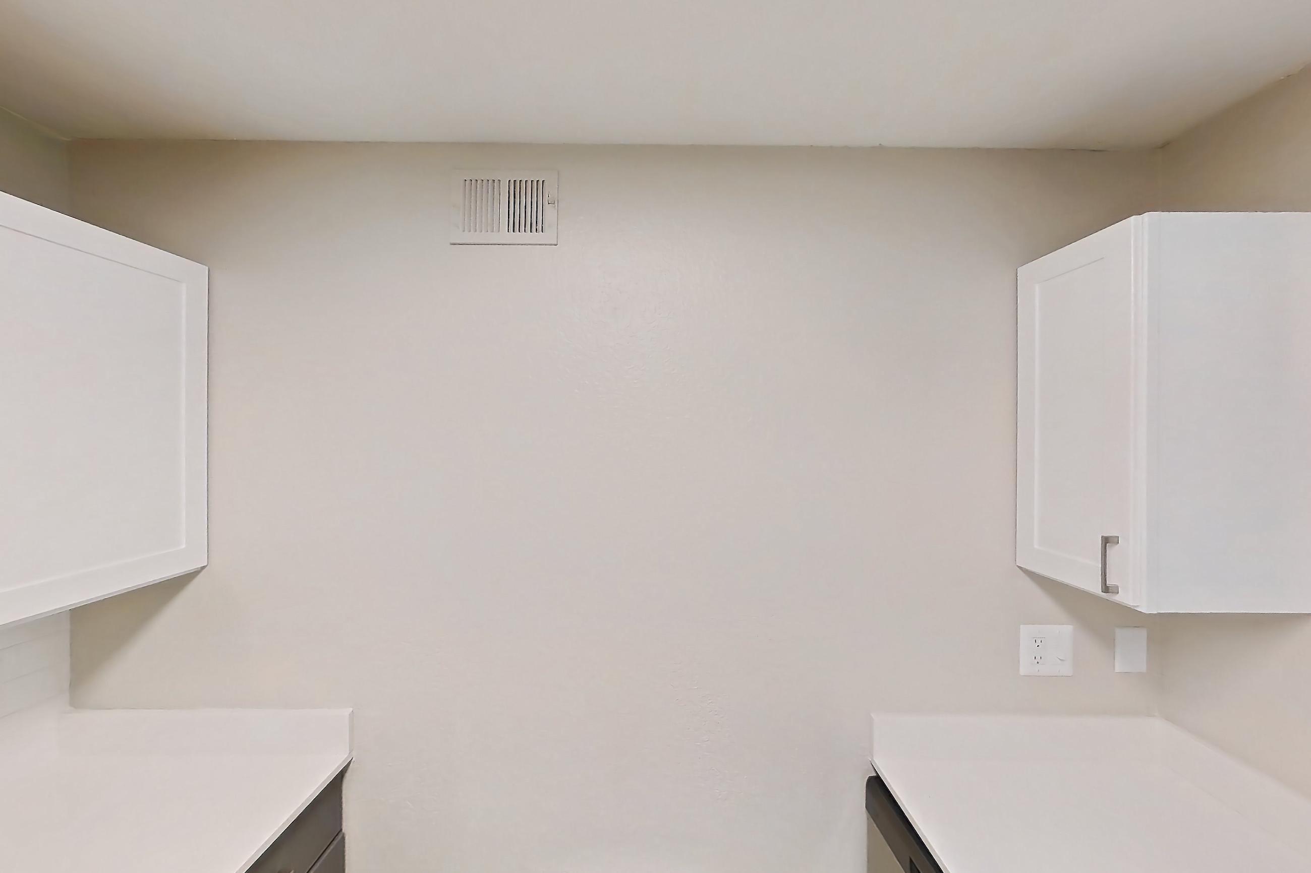 Kitchen with dishwasher, electric range, light countertops, light wood-finish flooring, microwave, oven/range, refrigerator, and stainless steel appliances, Apartment 15-102 at Boot Ranch