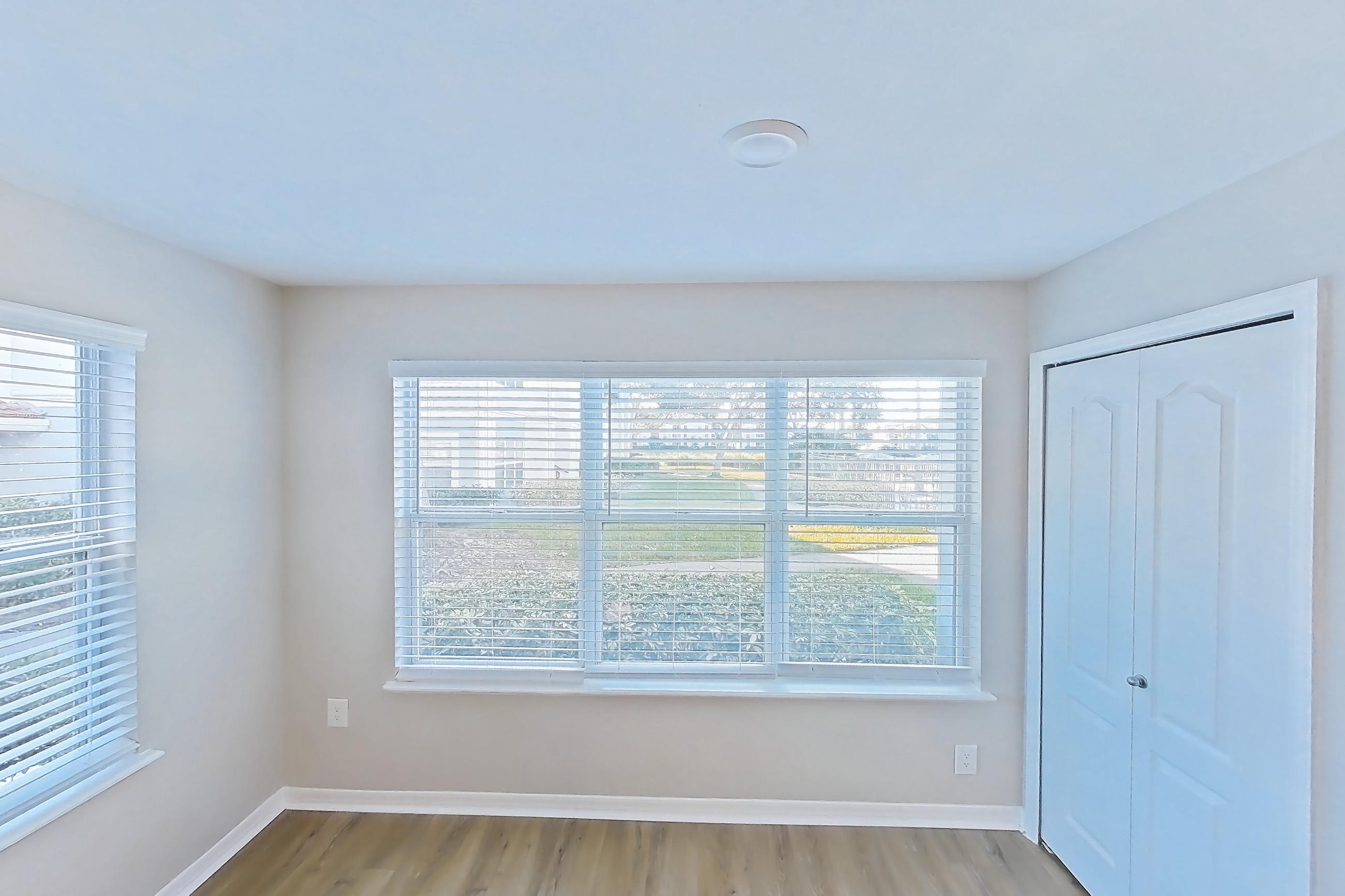 Living room with light wood-finish flooring, Apartment 15-102 at Boot Ranch