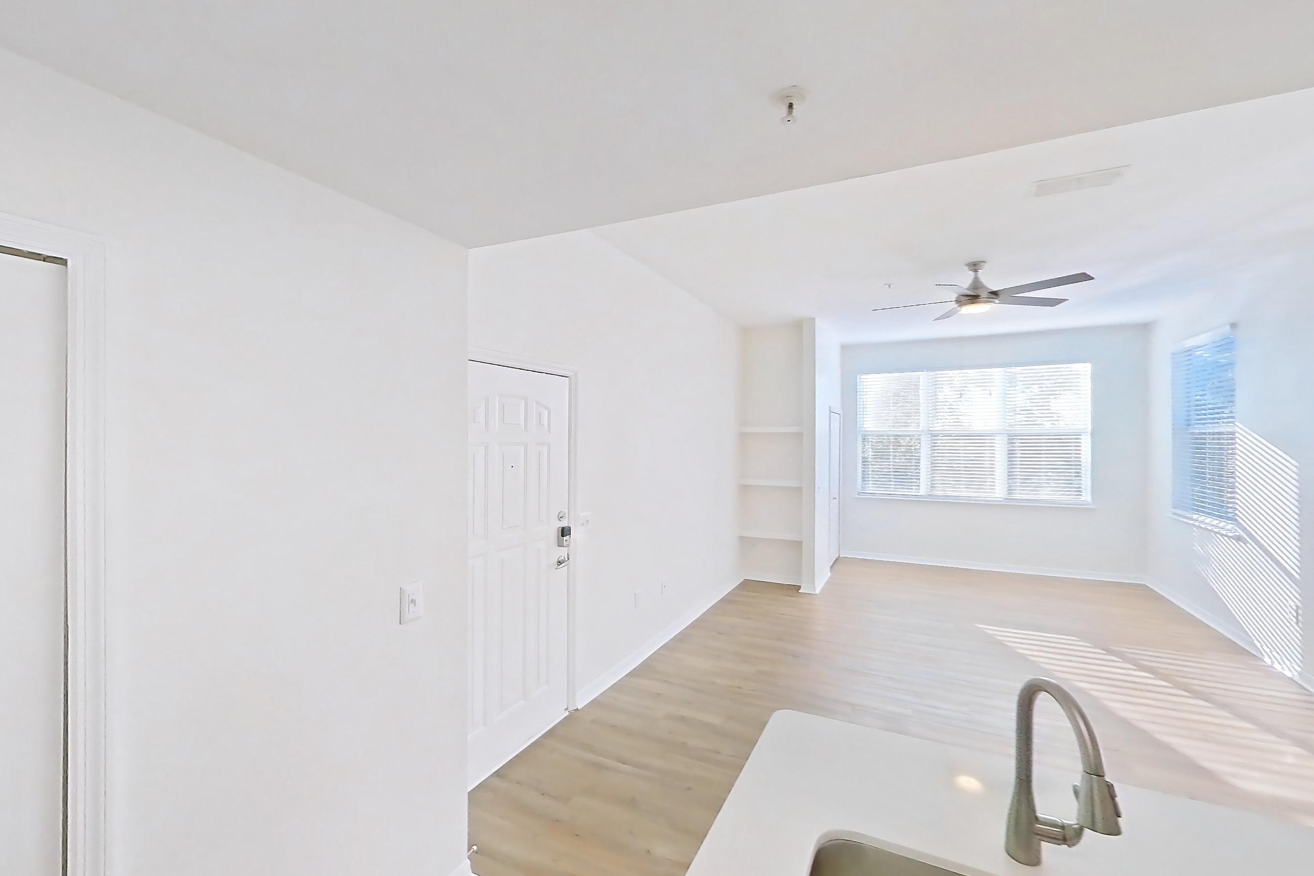 Kitchen with dishwasher, electric range, light countertops, light wood-finish flooring, microwave, oven/range, refrigerator, and stainless steel appliances, Apartment 15-308 at Boot Ranch