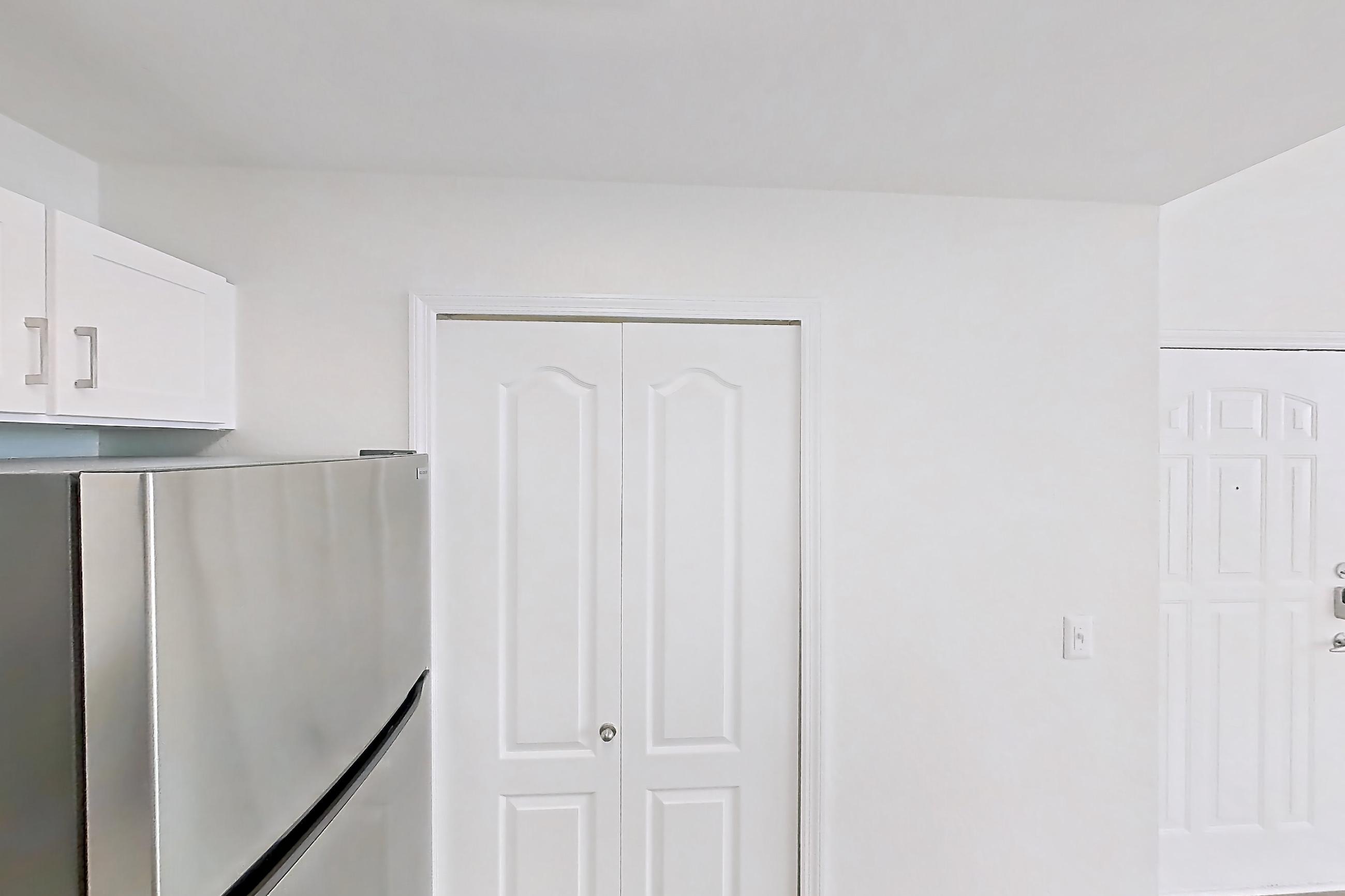 Kitchen with dishwasher, electric range, light countertops, light wood-finish flooring, microwave, oven/range, refrigerator, and stainless steel appliances, Apartment 15-308 at Boot Ranch