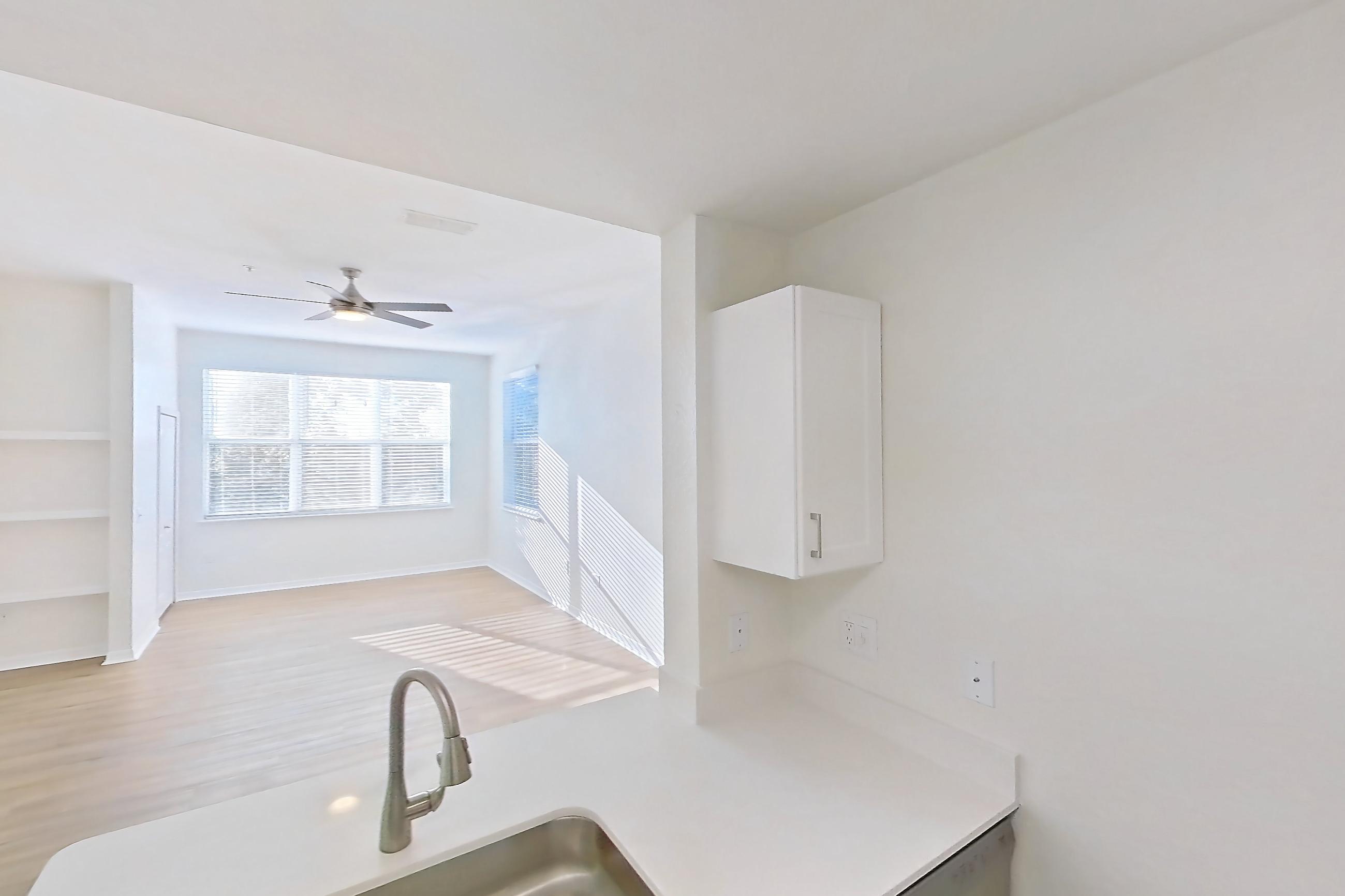 Kitchen with dishwasher, electric range, light countertops, light wood-finish flooring, microwave, oven/range, refrigerator, and stainless steel appliances, Apartment 15-308 at Boot Ranch