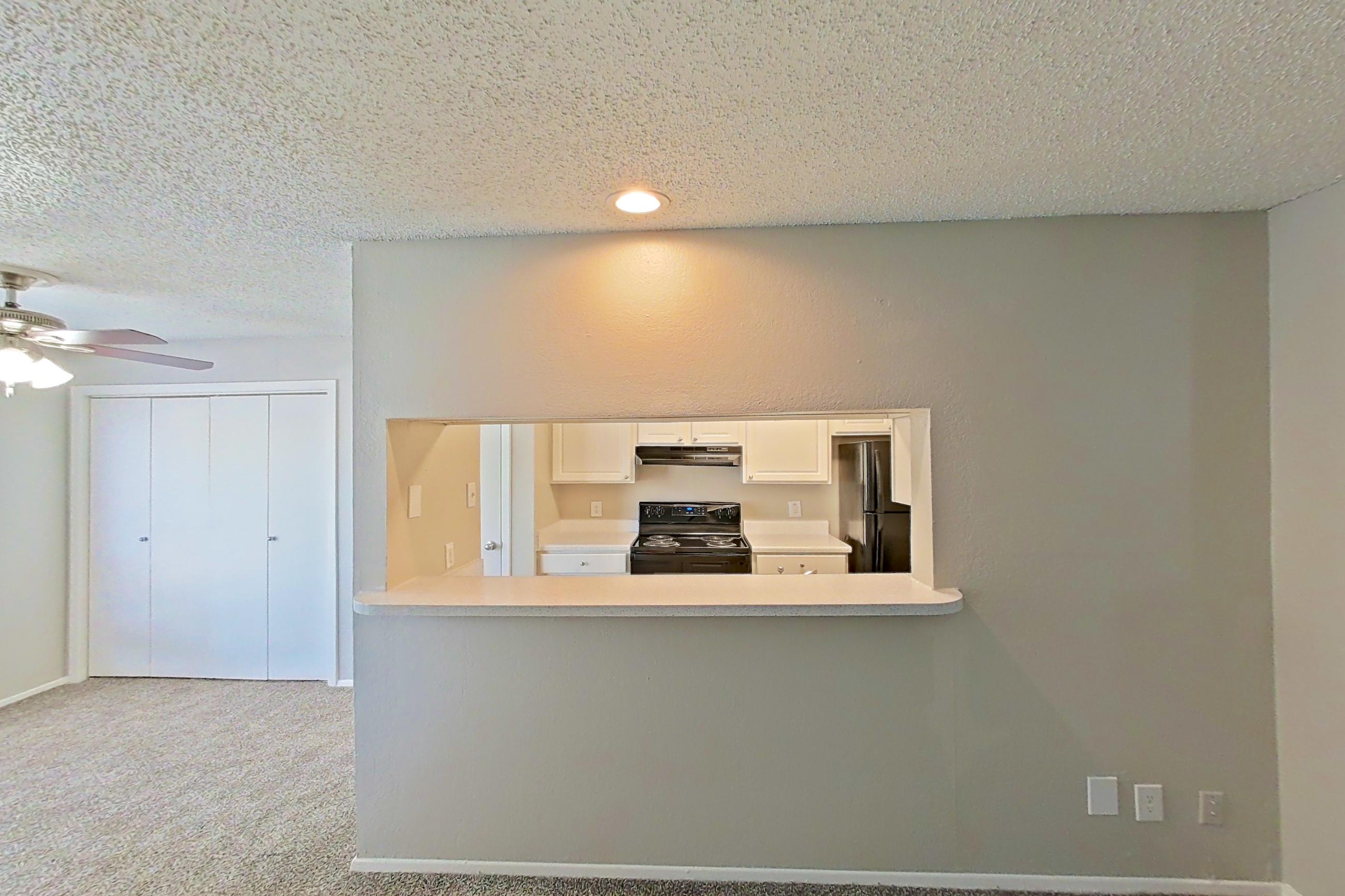 Living room with black appliances, electric range, fireplace, oven/range, and refrigerator, Apartment 0807 at Prestonwood Apartment Homes