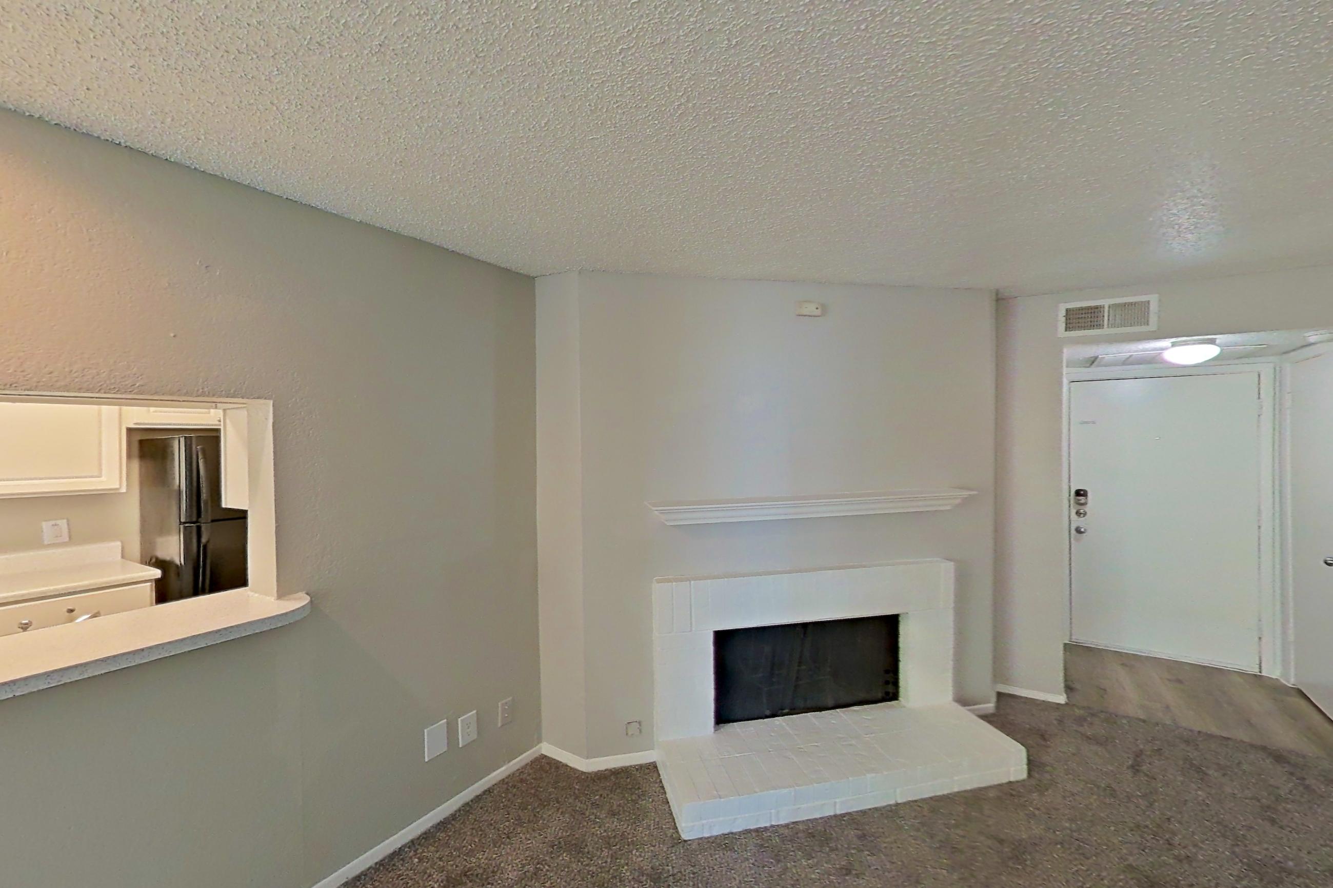 Living room with black appliances, electric range, fireplace, oven/range, and refrigerator, Apartment 0807 at Prestonwood Apartment Homes
