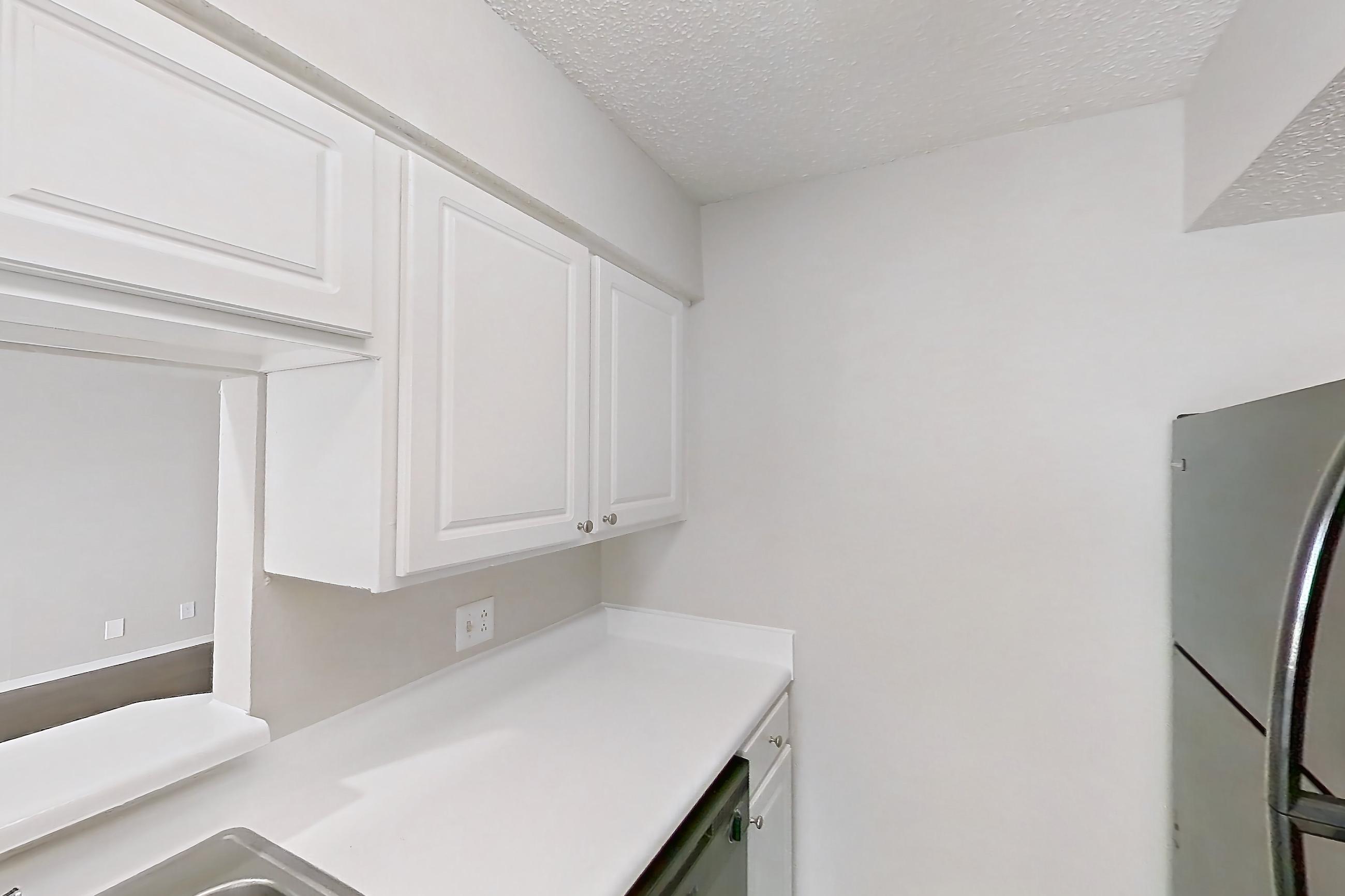 Kitchen with black appliances, dark wood-finish flooring, dishwasher, electric range, light countertops, oven/range, and refrigerator, Apartment 1506 at Prestonwood Apartment Homes