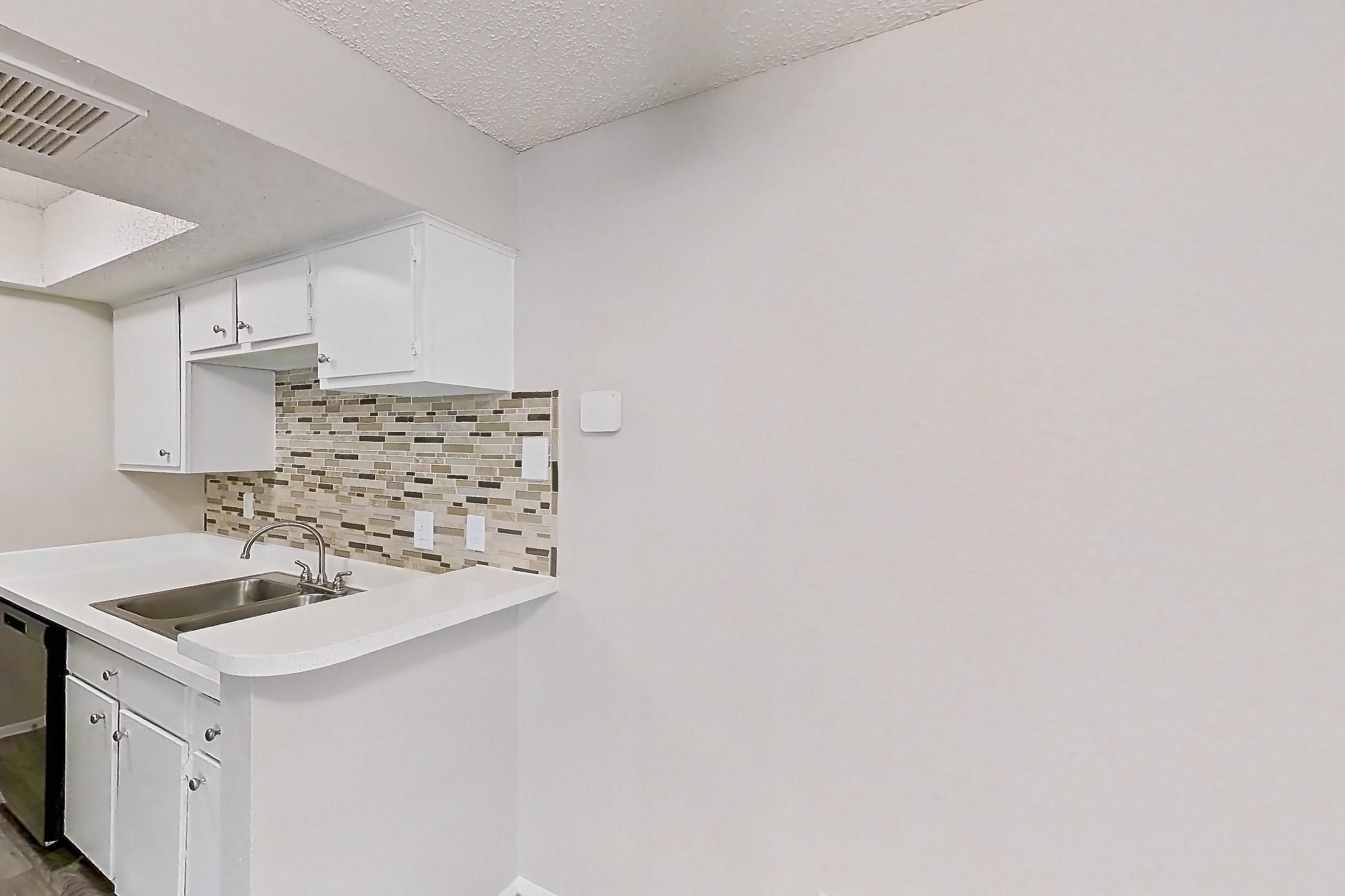 Dining room with black appliances, dishwasher, electric range, light carpet, light countertops, light wood-finish flooring, oven/range, refrigerator, and stainless steel appliances, Apartment 2013 at Enclave at Prestonwood