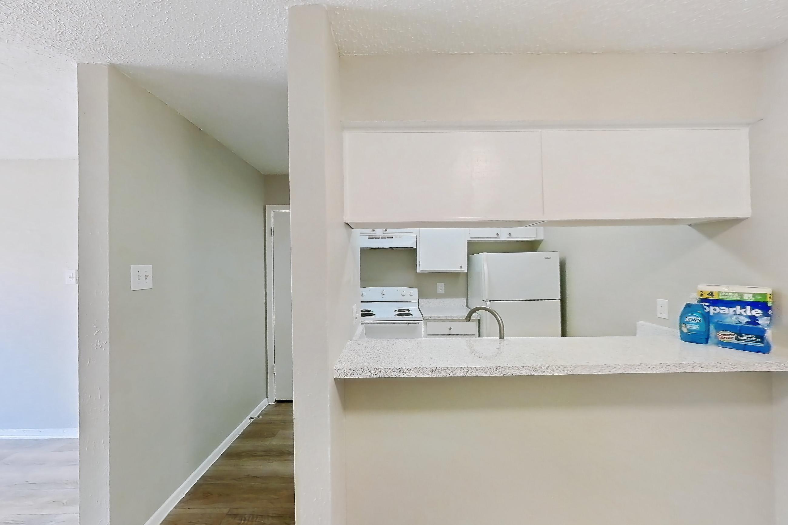 Dining room with electric range, light wood-finish flooring, oven/range, refrigerator, and white appliances, Apartment 404 at Westgate