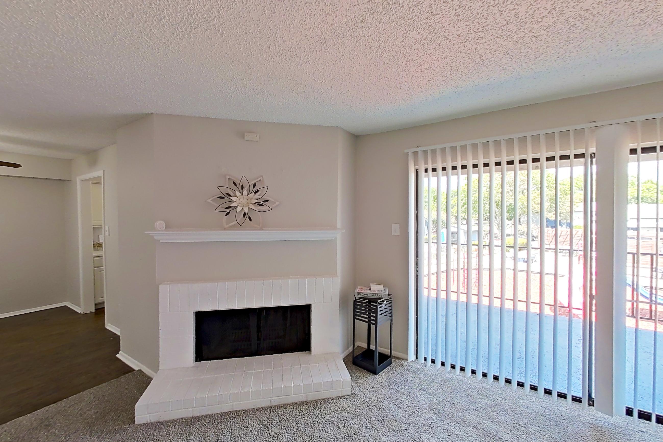 Living room with brick fireplace and fireplace, Apartment 0901 at Prestonwood Apartment Homes