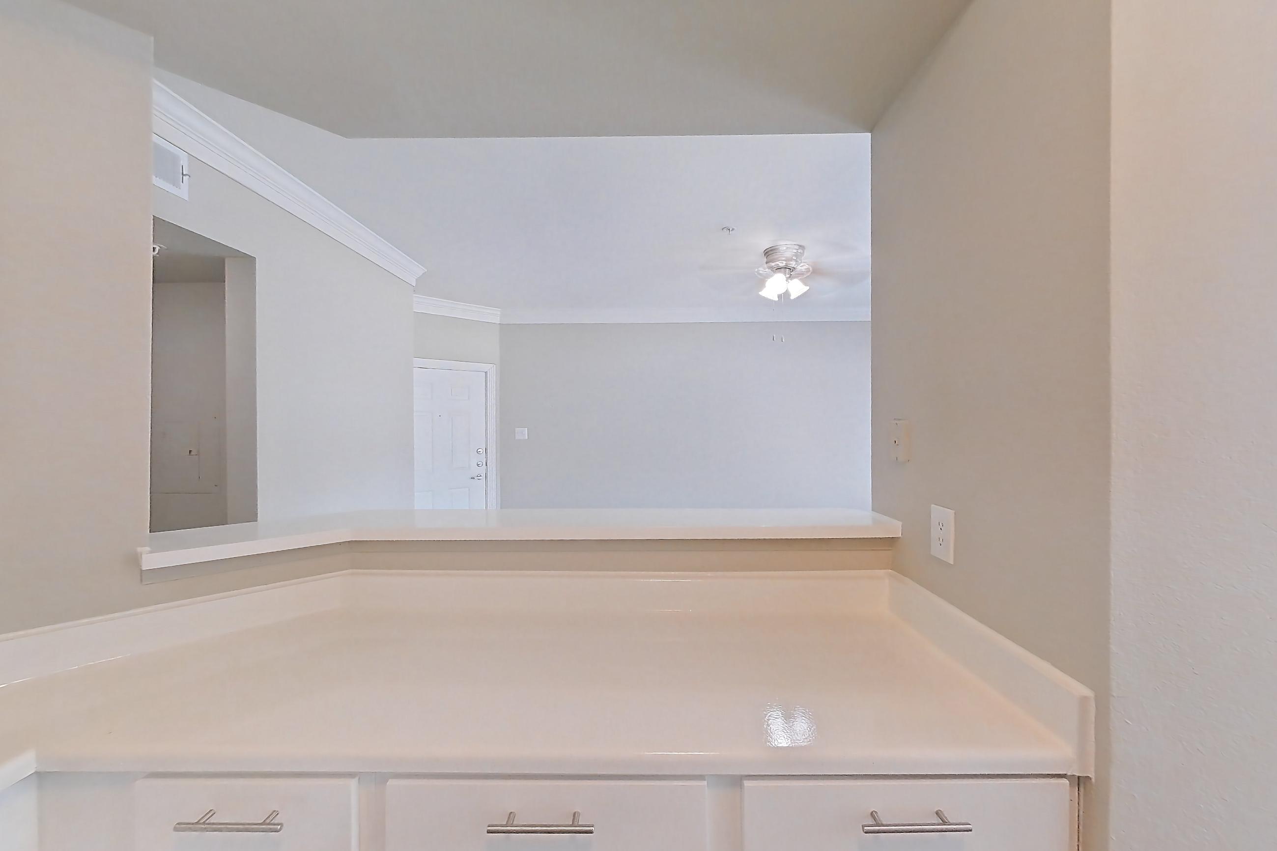 Kitchen with dark wood-finish flooring, dishwasher, electric range, light countertops, light wood-finish flooring, oven/range, refrigerator, stainless steel appliances, and wood-look tile flooring, Apartment 805 at Champions Centre