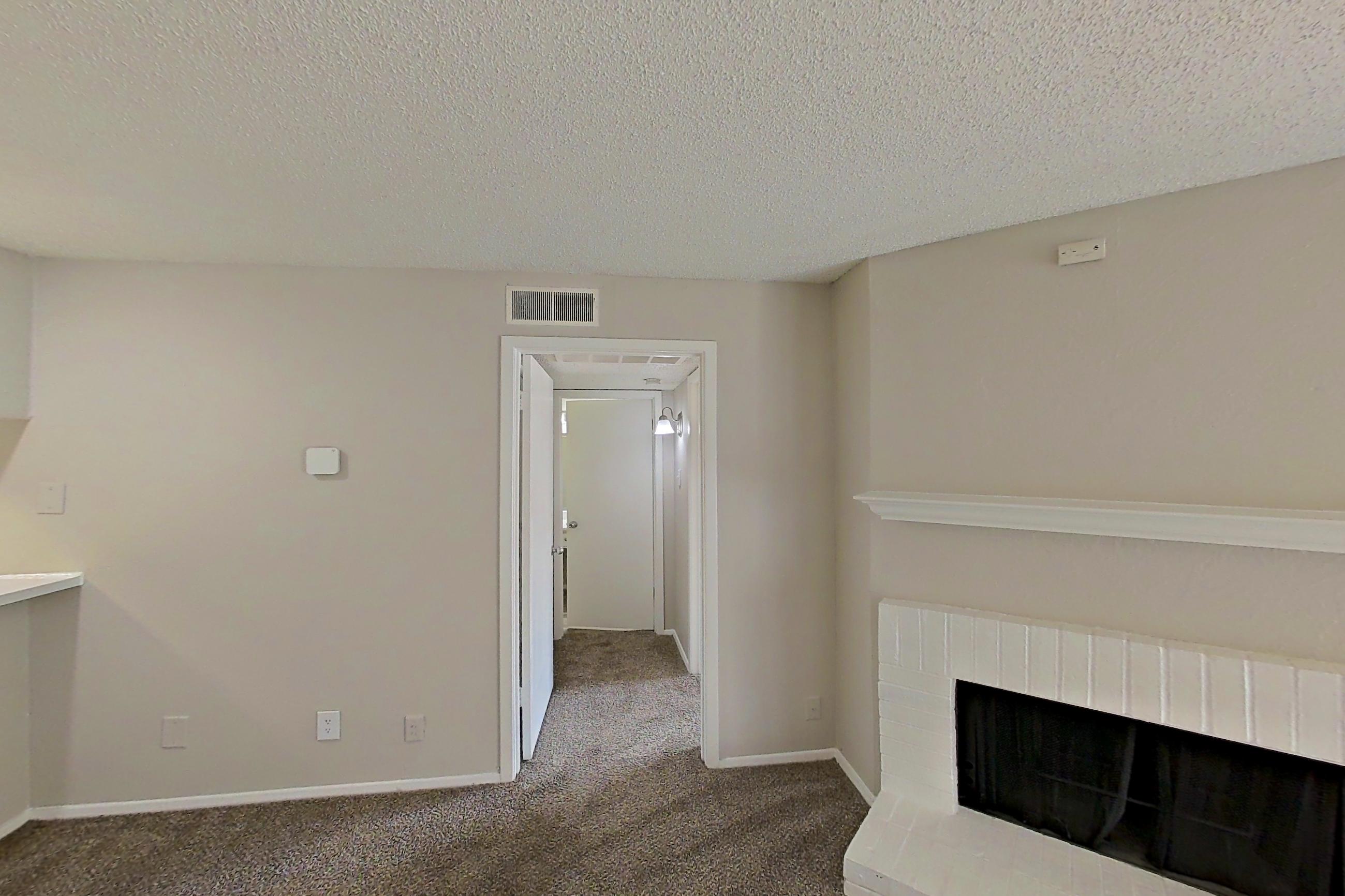 Living room with black appliances, brick fireplace, electric range, fireplace, and oven/range, Apartment 0309 at Prestonwood Apartment Homes