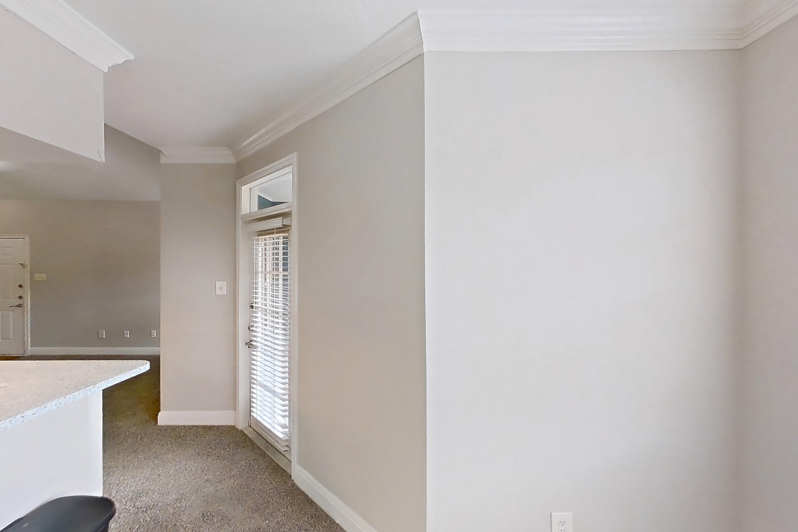 Dining room with black appliances, electric range, light carpet, light countertops, microwave, oven/range, refrigerator, and stainless steel appliances, Apartment 0613 at Champions Park