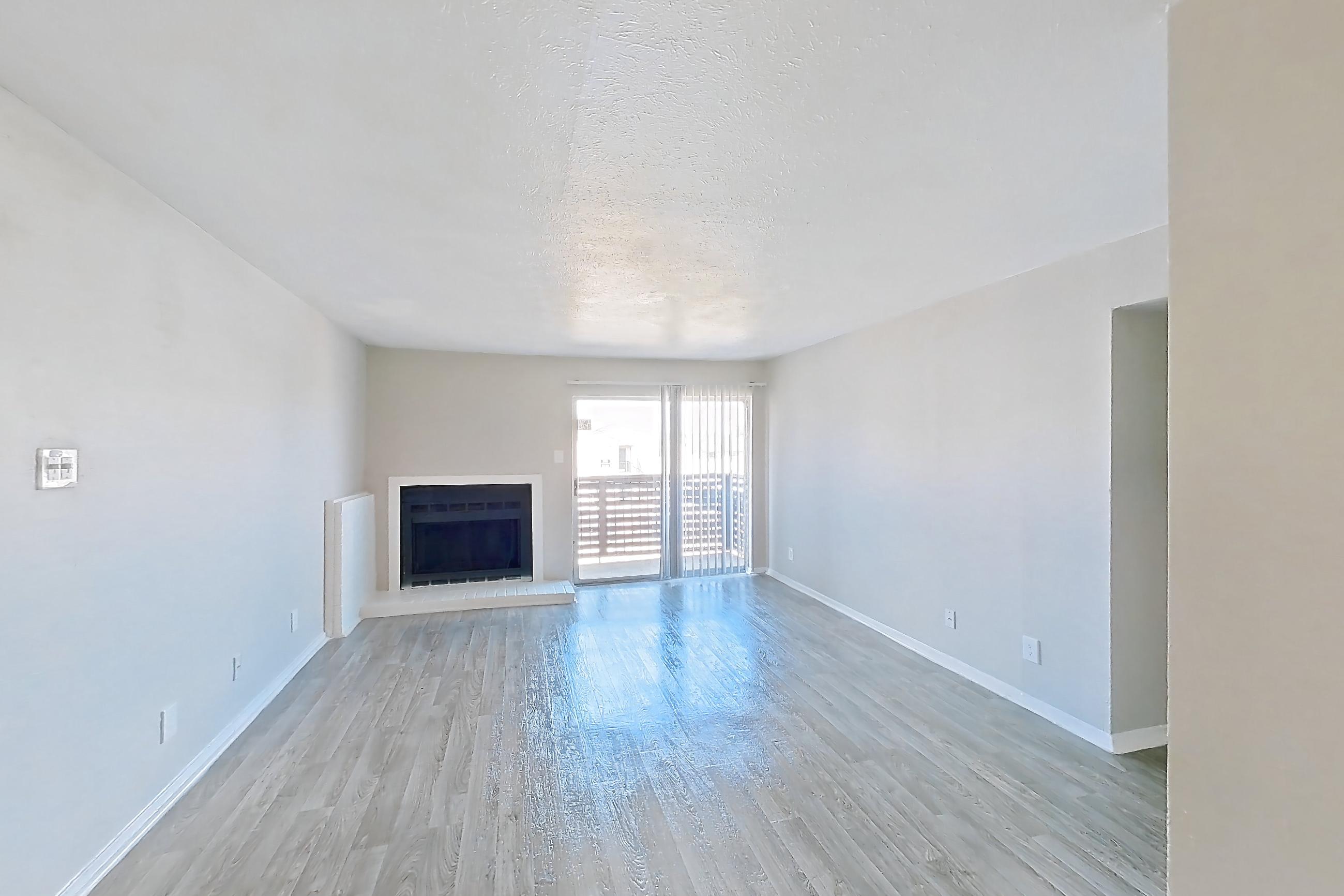 Dining room with black appliances, electric range, fireplace, light wood-finish flooring, and oven/range, Apartment 1322 at Westgate