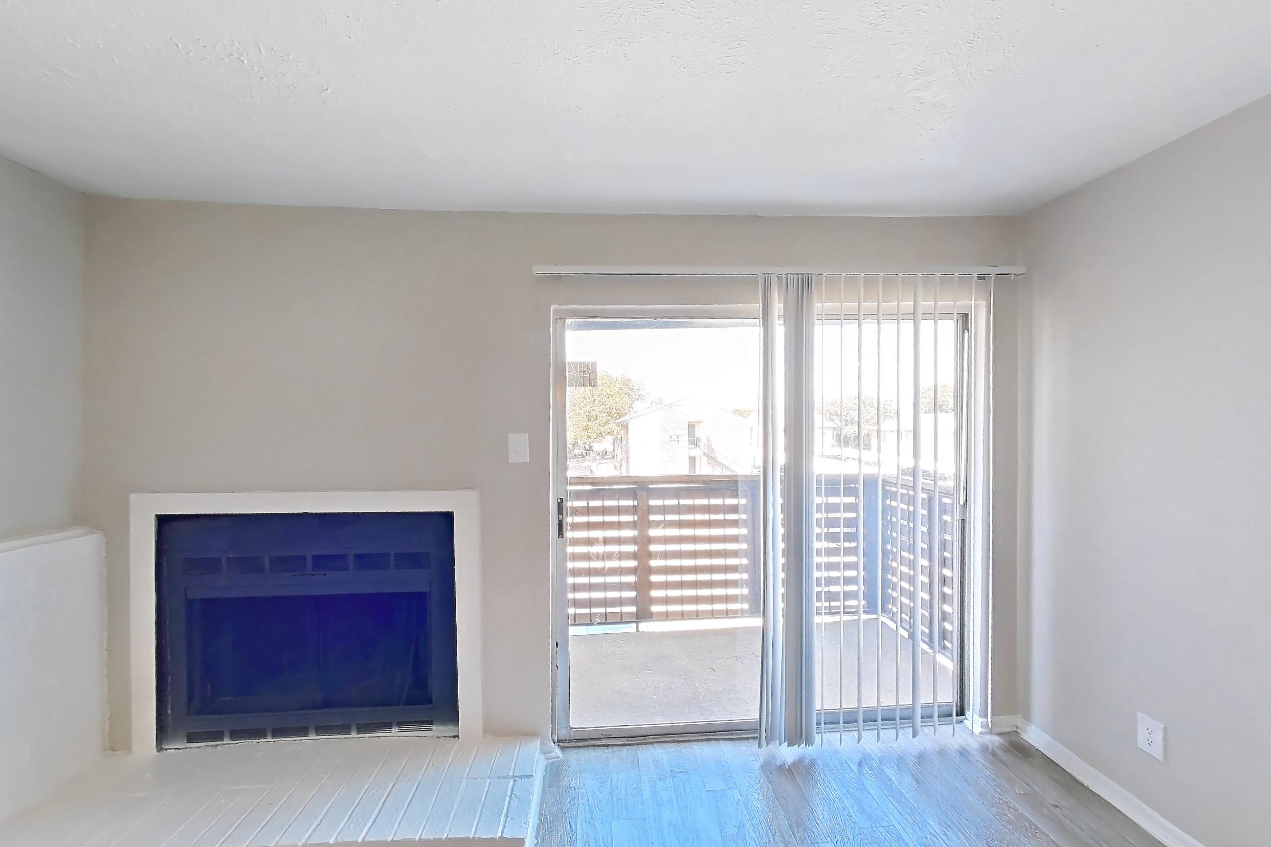 Living room with brick fireplace, fireplace, and light wood-finish flooring, Apartment 1322 at Westgate