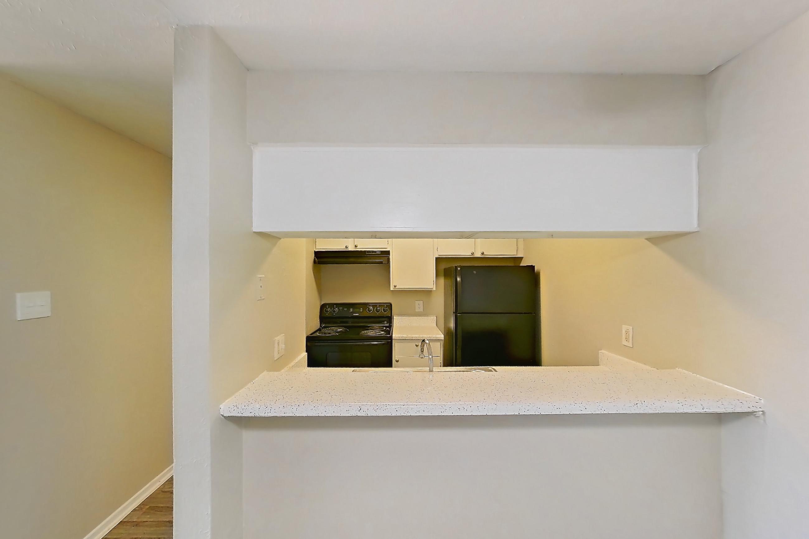 Dining room with black appliances, electric range, light stone countertops, light wood-finish flooring, oven/range, and refrigerator, Apartment 2121 at Westgate