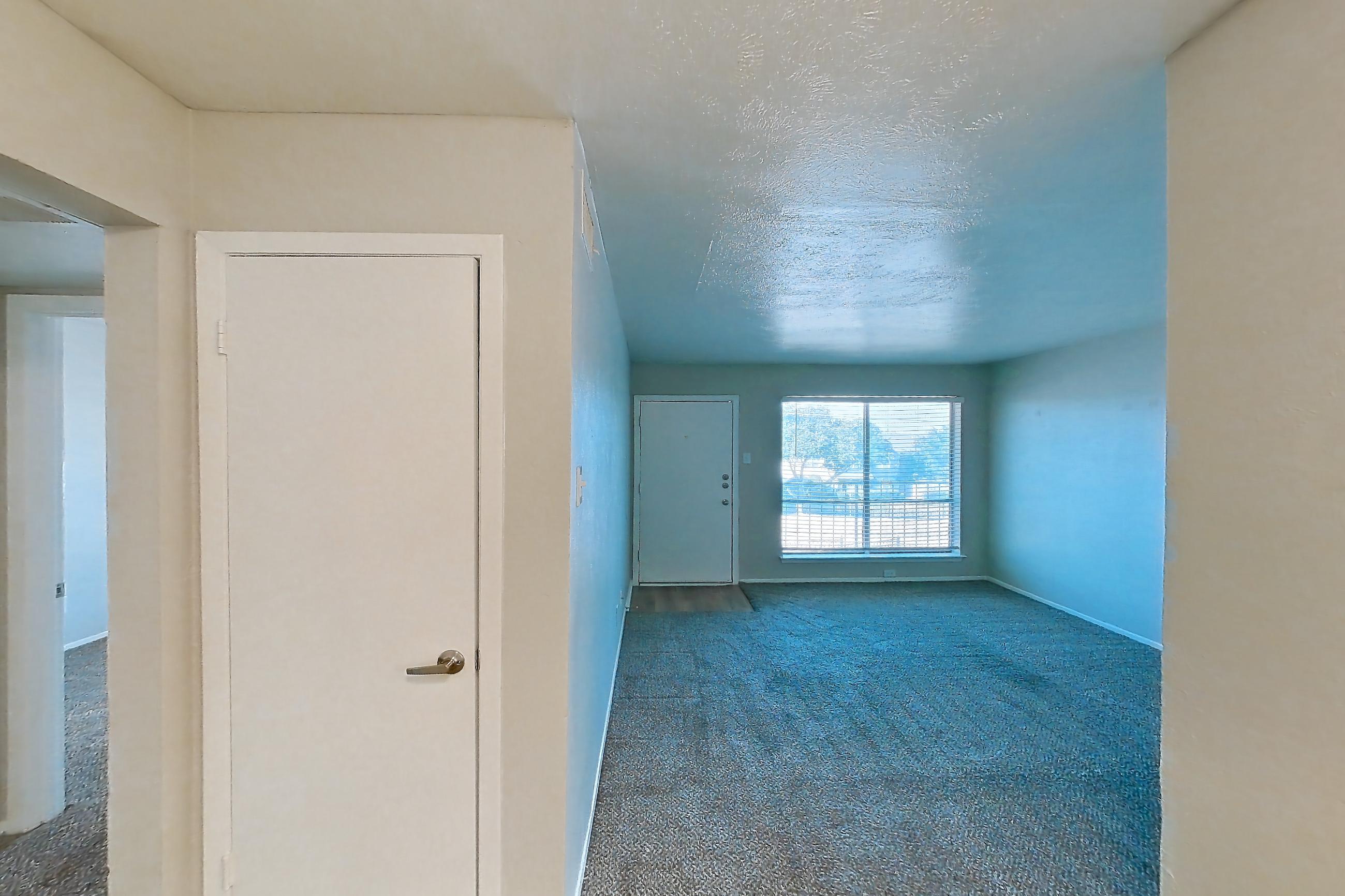 Dining room with dishwasher, light carpet, light stone countertops, refrigerator, stainless steel appliances, and white appliances, Apartment 10 at Loreto Apartment Homes