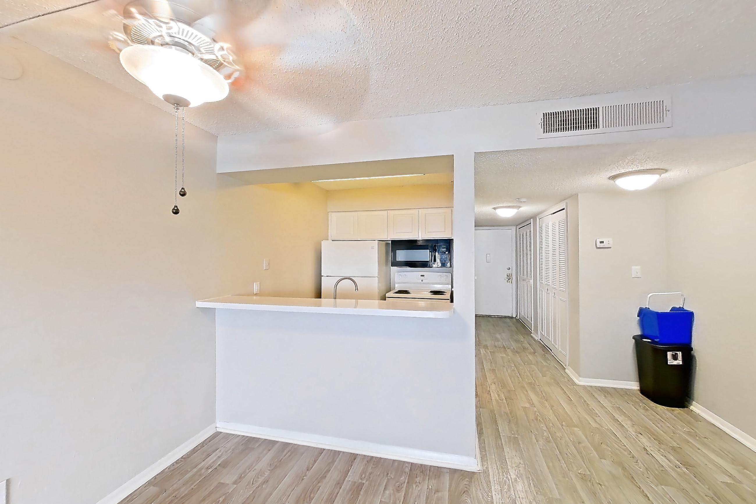 Living room with electric range, light wood-finish flooring, oven/range, and white appliances, Apartment C-88 at Sunset Place