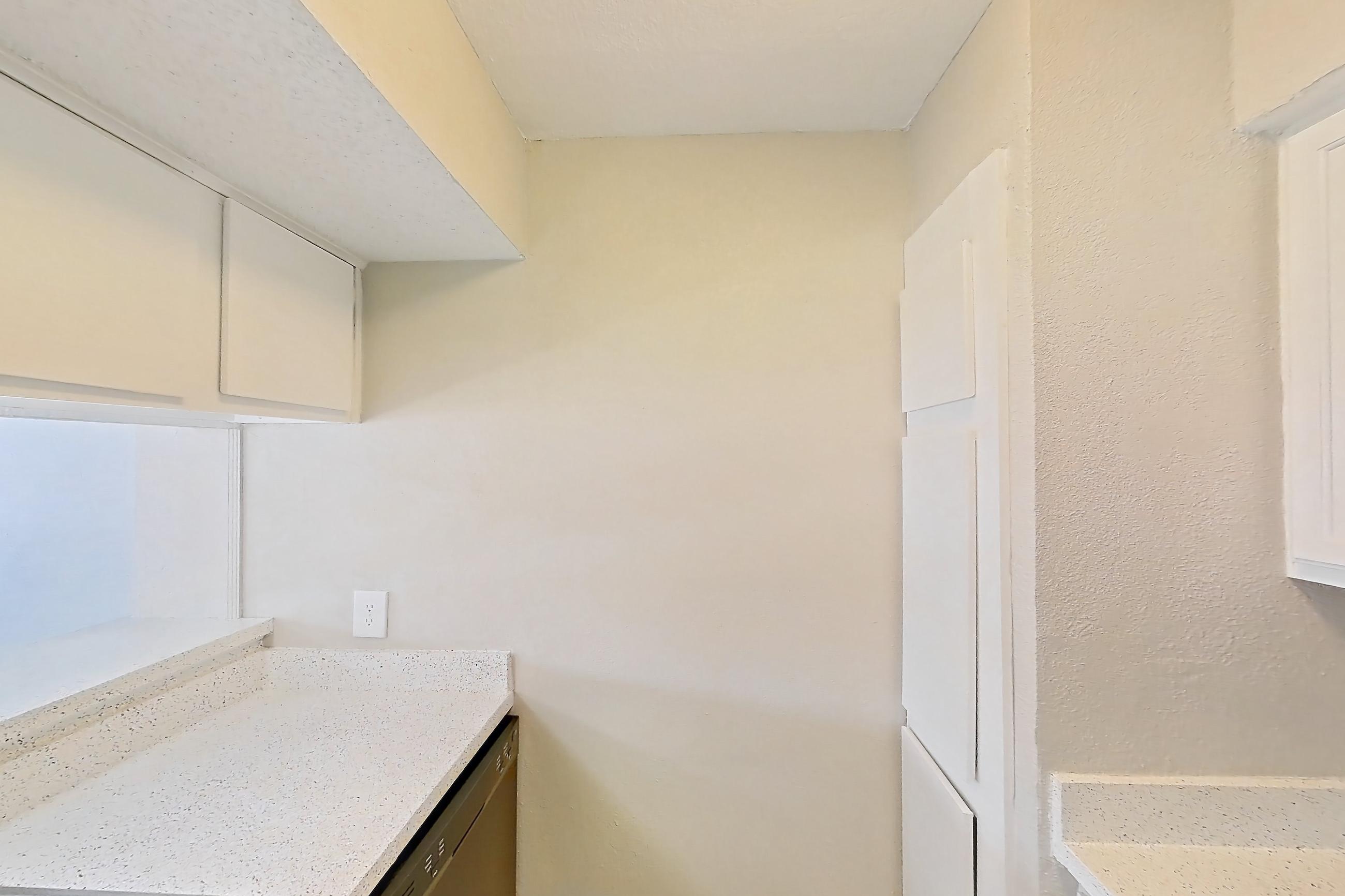 Kitchen with black appliances, dishwasher, electric range, light countertops, light stone countertops, light wood-finish flooring, oven/range, and refrigerator, Apartment 182 at Sedona Park