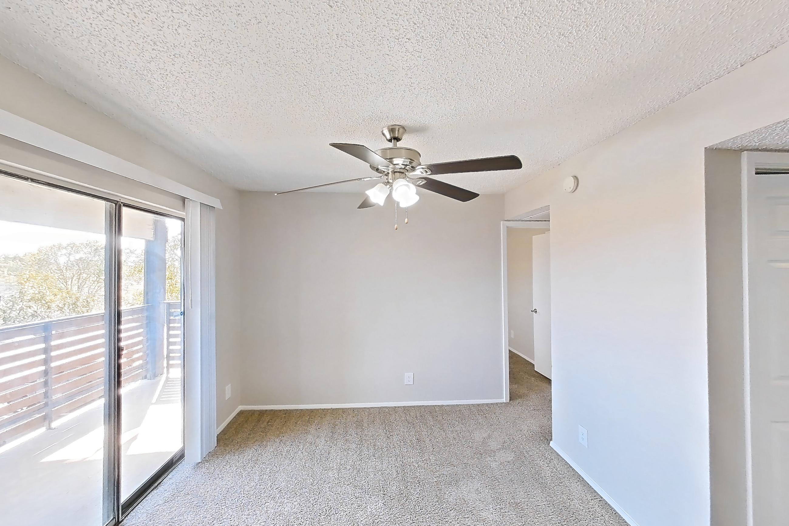 Living room with black appliances, brick fireplace, electric range, fireplace, oven/range, and refrigerator, Apartment 225 at Sedona Park