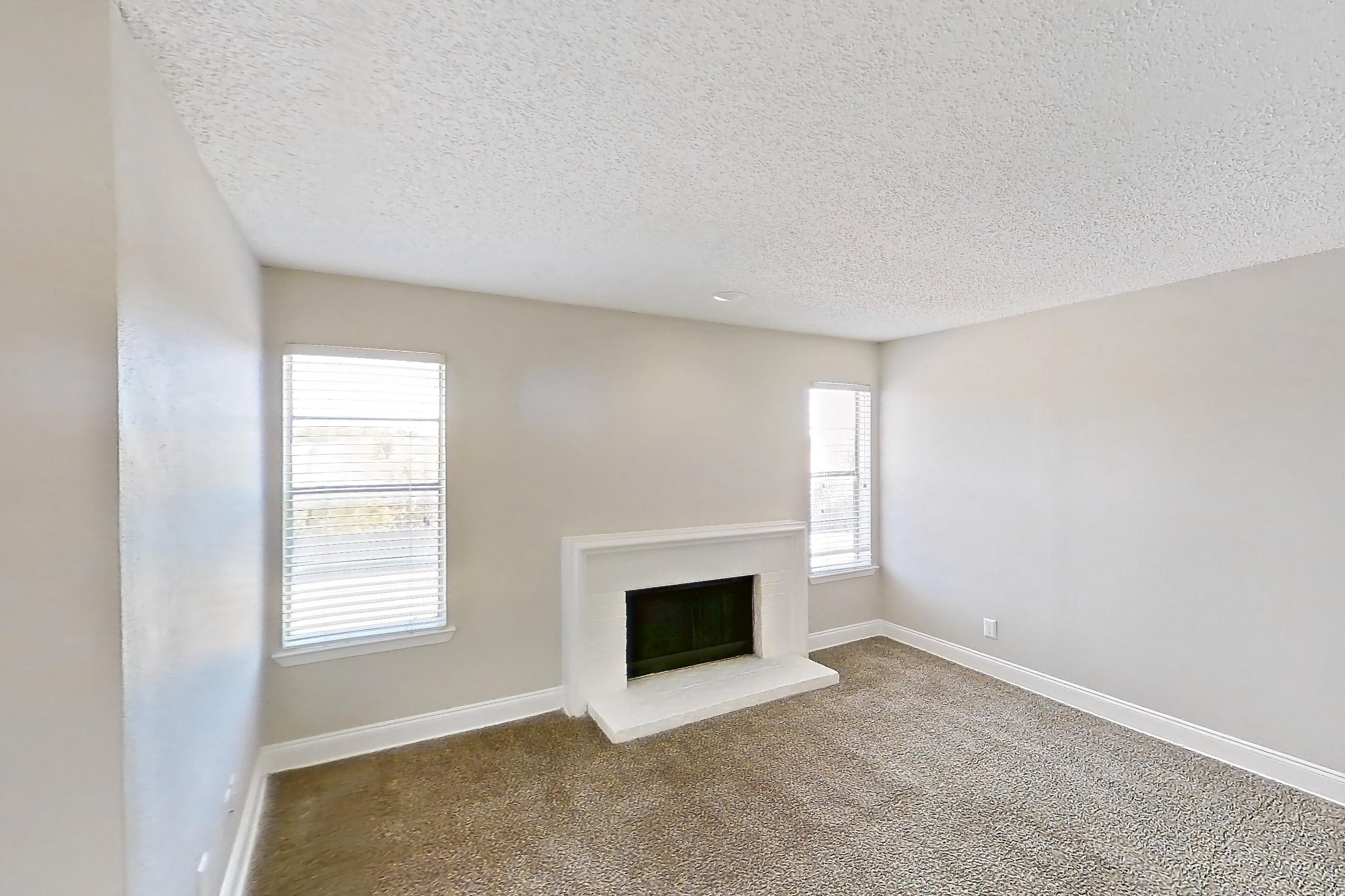 Living room with black appliances, dark carpet, electric range, fireplace, light countertops, oven/range, and wood-look tile flooring, Apartment 232 at Sedona Park