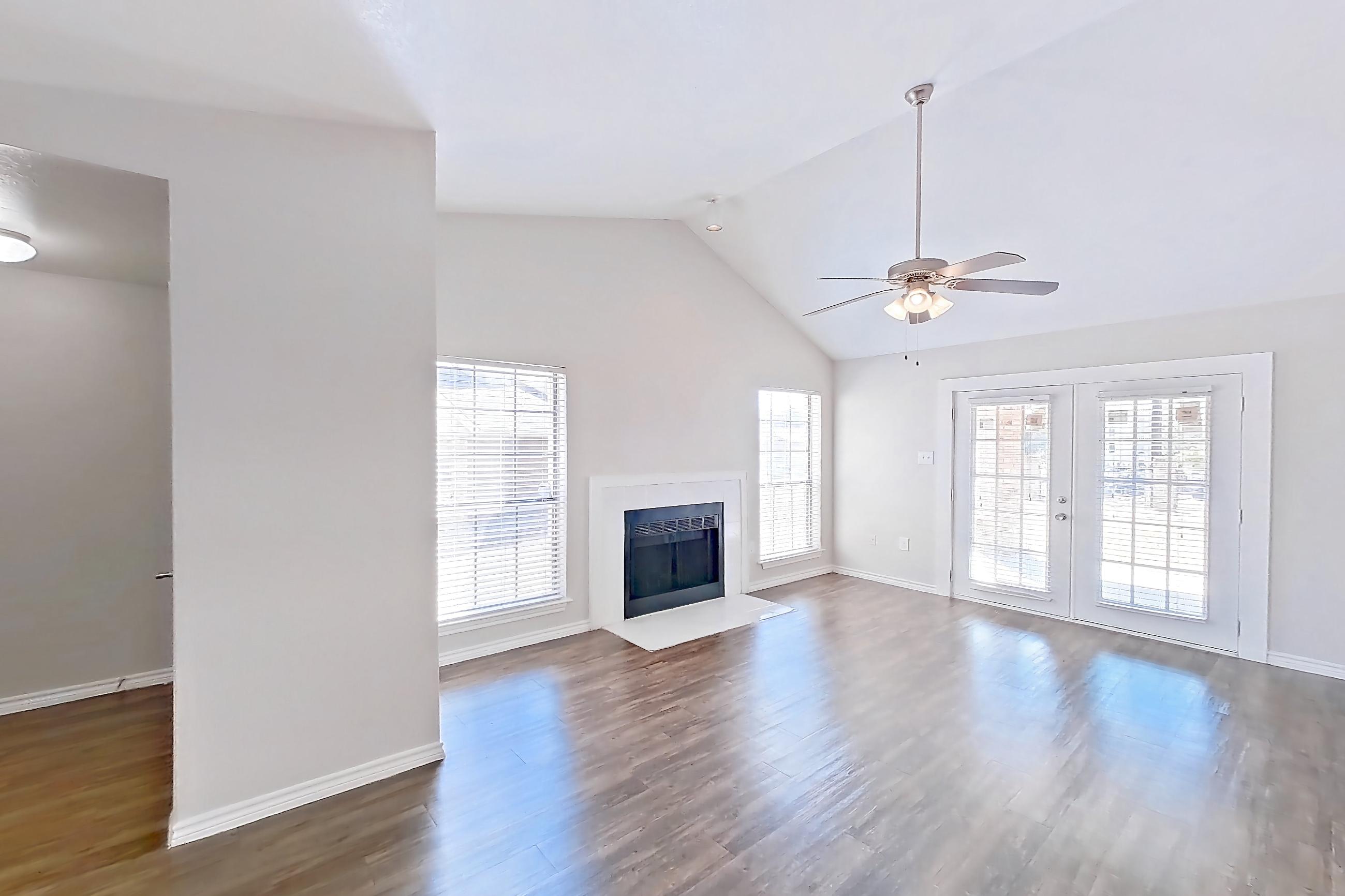 Dining room with black appliances, dark wood-finish flooring, fireplace, and oven/range, Apartment 1211 at Arlington Hills