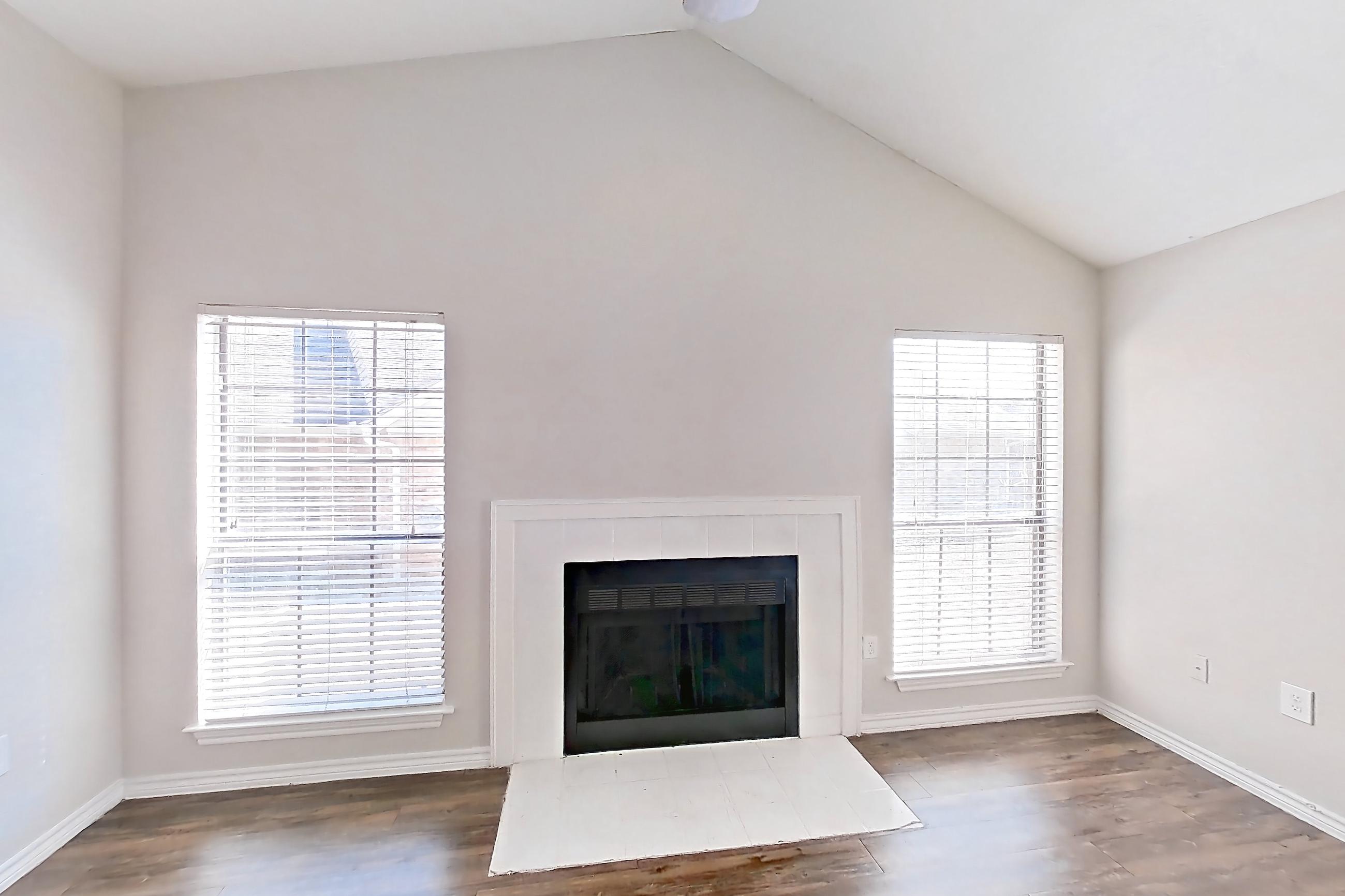 Living room with dark wood-finish flooring, fireplace, and tile fireplace, Apartment 1211 at Arlington Hills