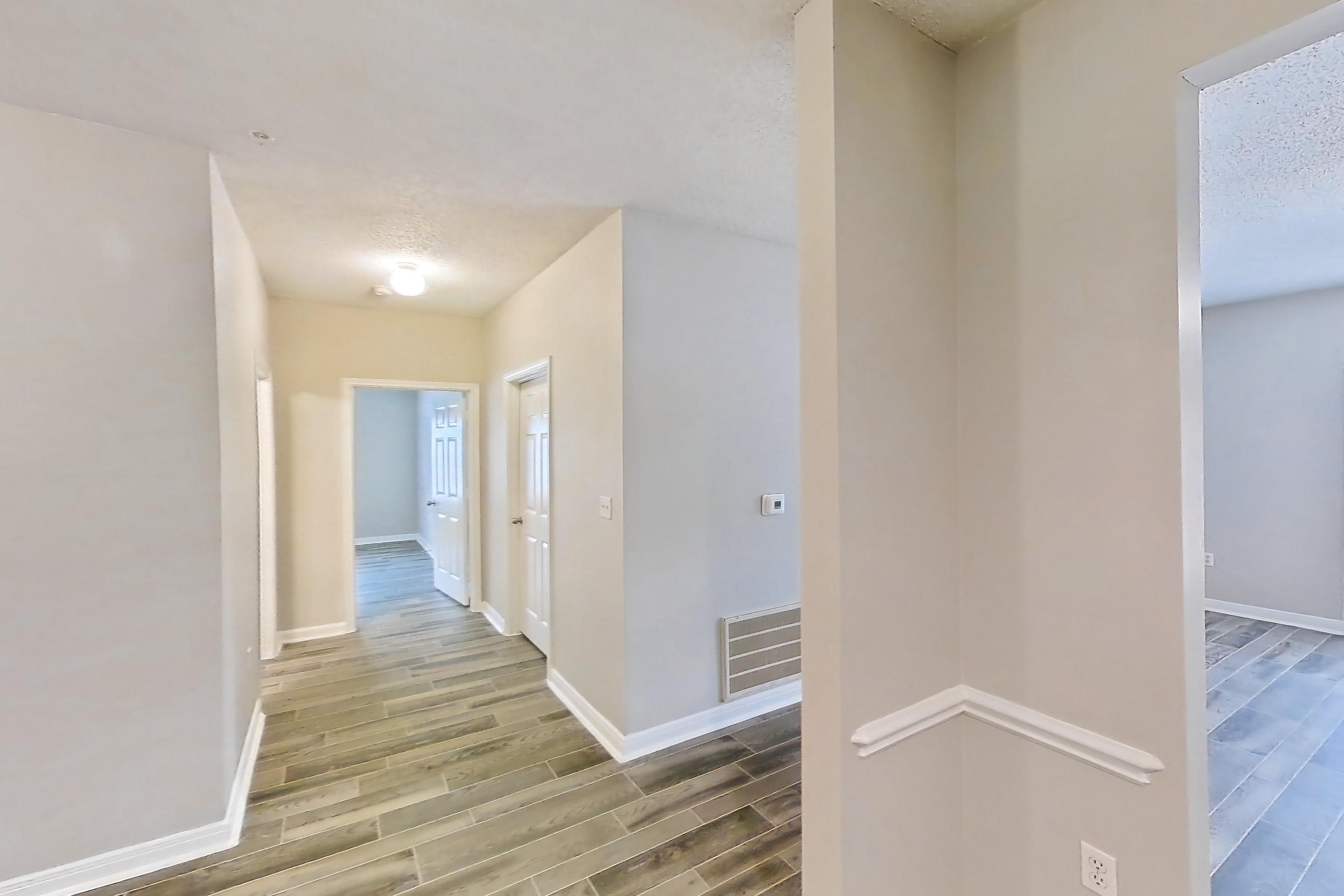 Living space with light wood-finish flooring and wood-look tile flooring, Apartment 802 at Grand Palms