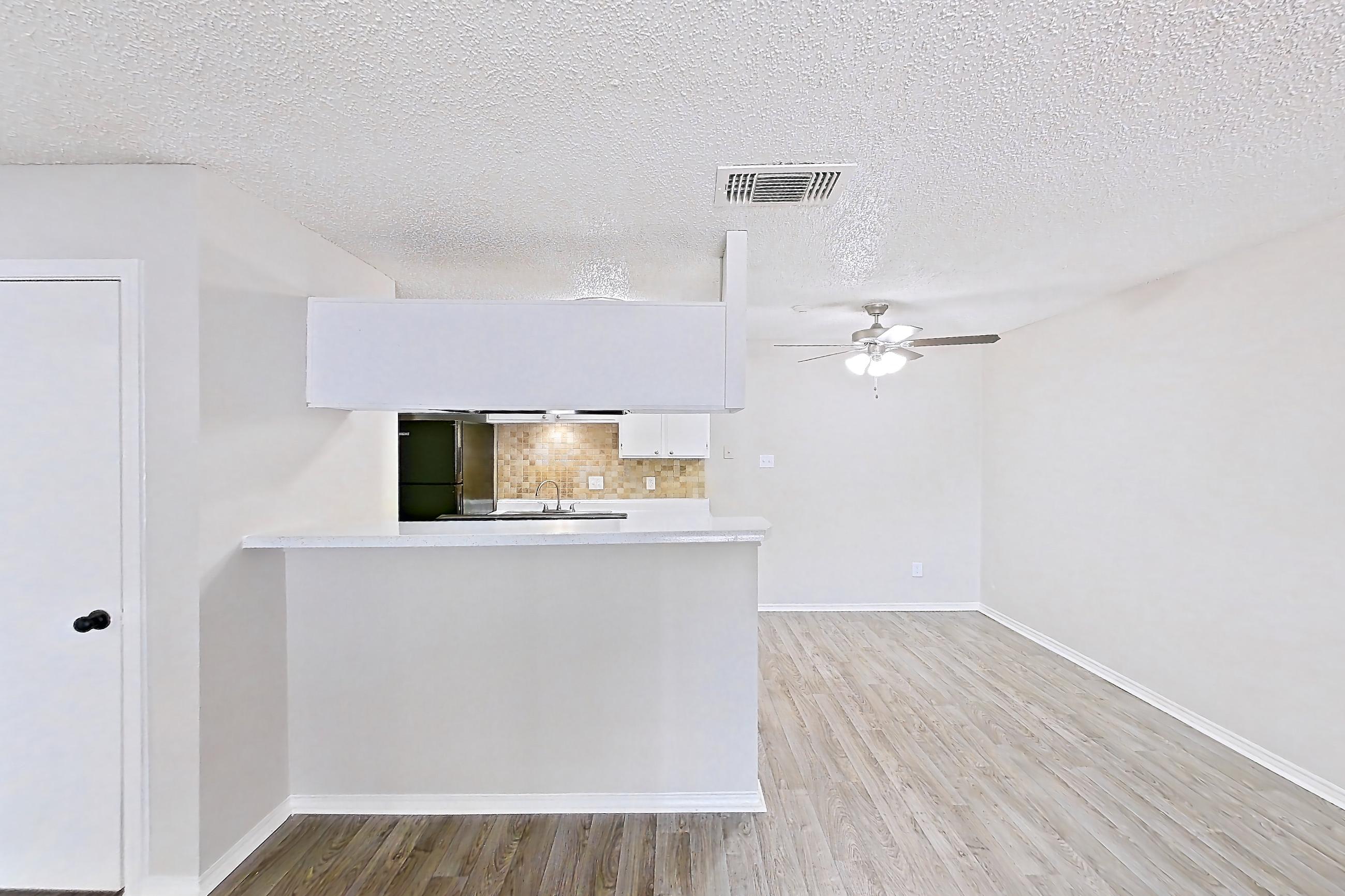 Living room with light wood-finish flooring, Apartment 1605P at The Carmel