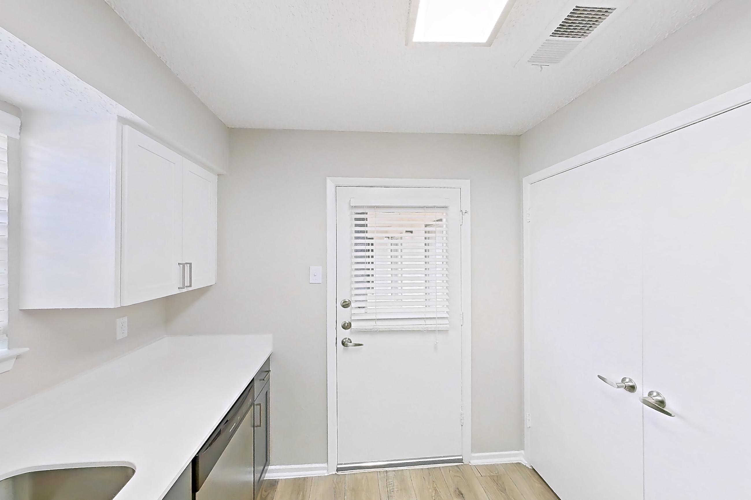 Kitchen with electric range, light countertops, light wood-finish flooring, oven/range, refrigerator, and stainless steel appliances, Apartment 1104 at Bella Vista