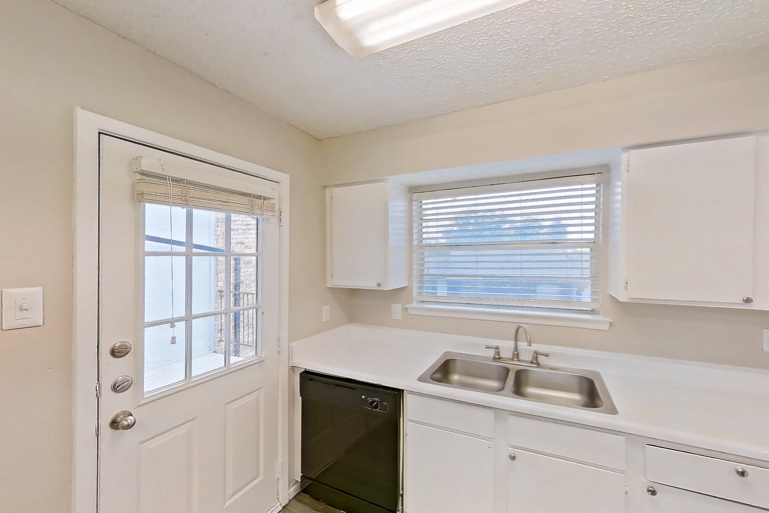 Kitchen with black appliances, dishwasher, electric range, light countertops, light wood-finish flooring, oven/range, and refrigerator, Apartment 4104 at Bella Vista