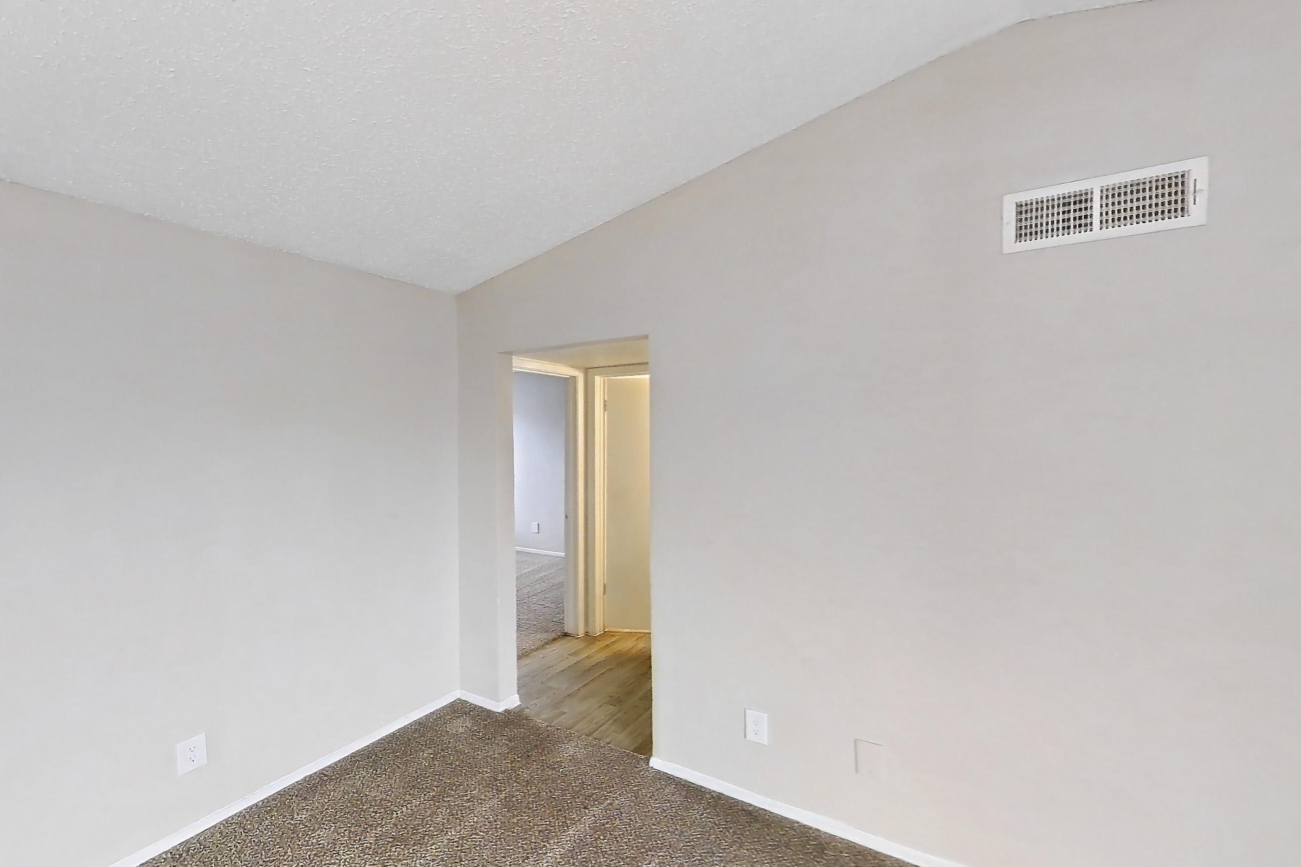 Living room with black appliances, electric range, fireplace, light carpet, and oven/range, Apartment 4104 at Bella Vista