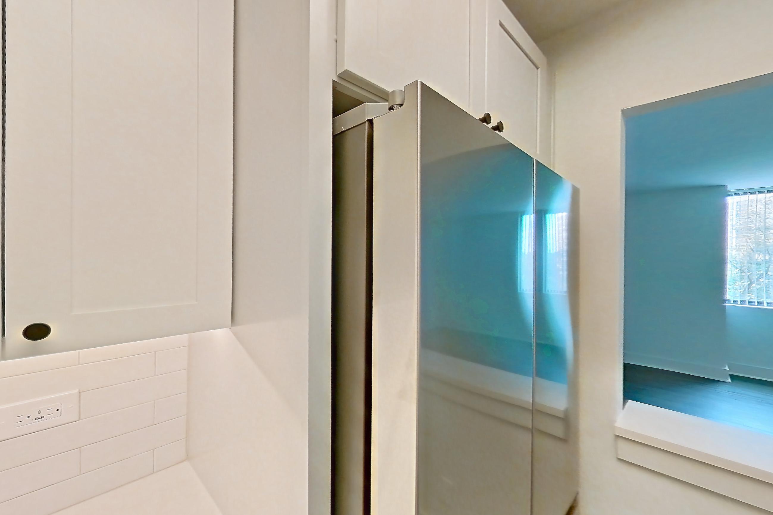 Kitchen with dark wood-finish flooring, electric range, light countertops, light stone countertops, microwave, oven/range, and stainless steel appliances, Apartment 409 at Cortland at McLean