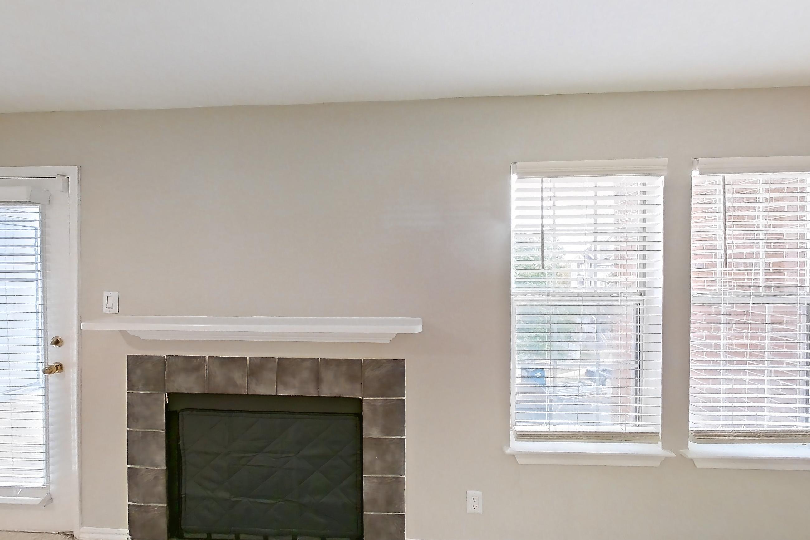 Living room with fireplace, light carpet, and tile fireplace, Apartment 4206 at Cortland Van Dorn