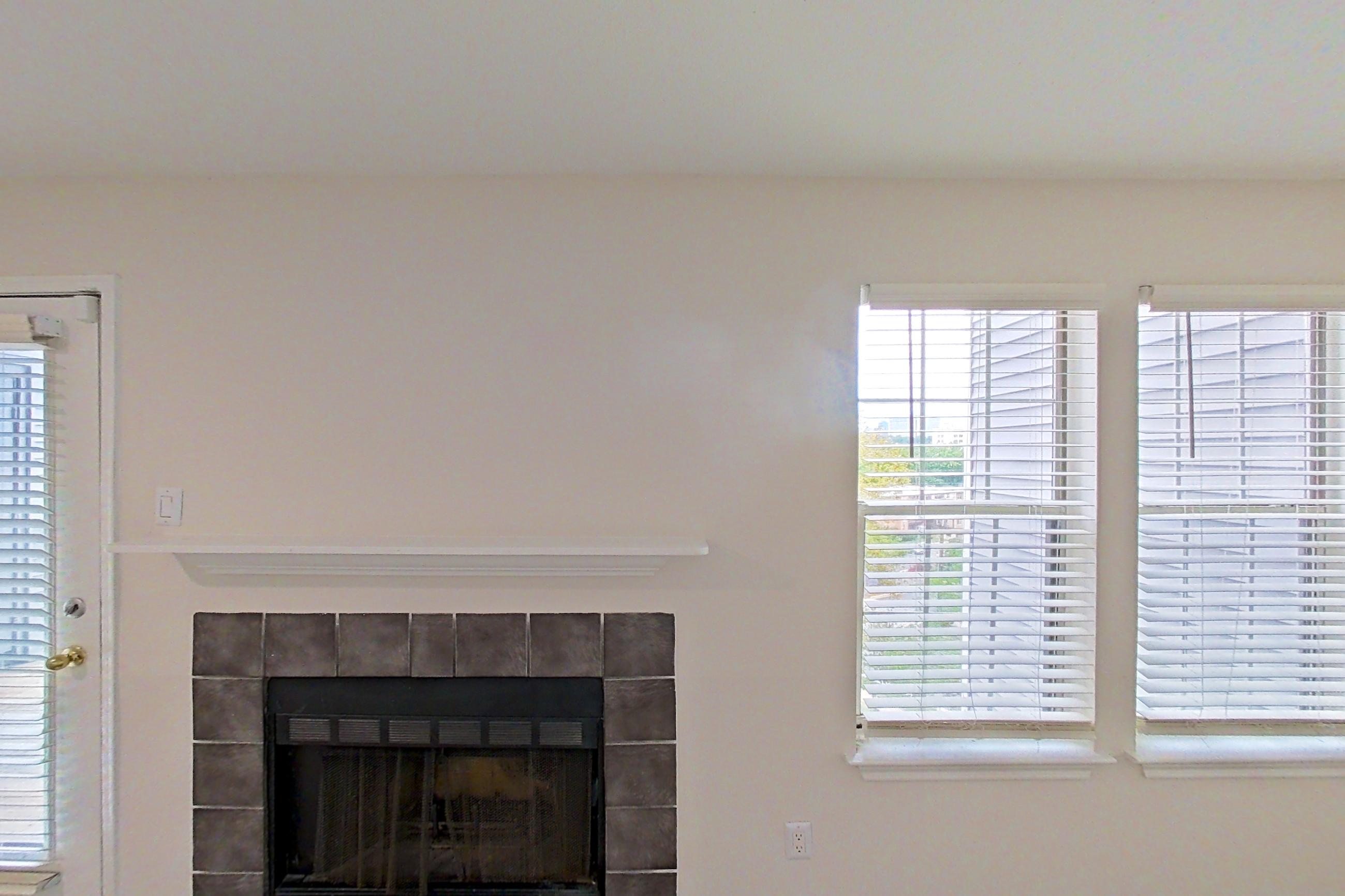 Living room with fireplace and tile fireplace, Apartment 7305 at Cortland Van Dorn