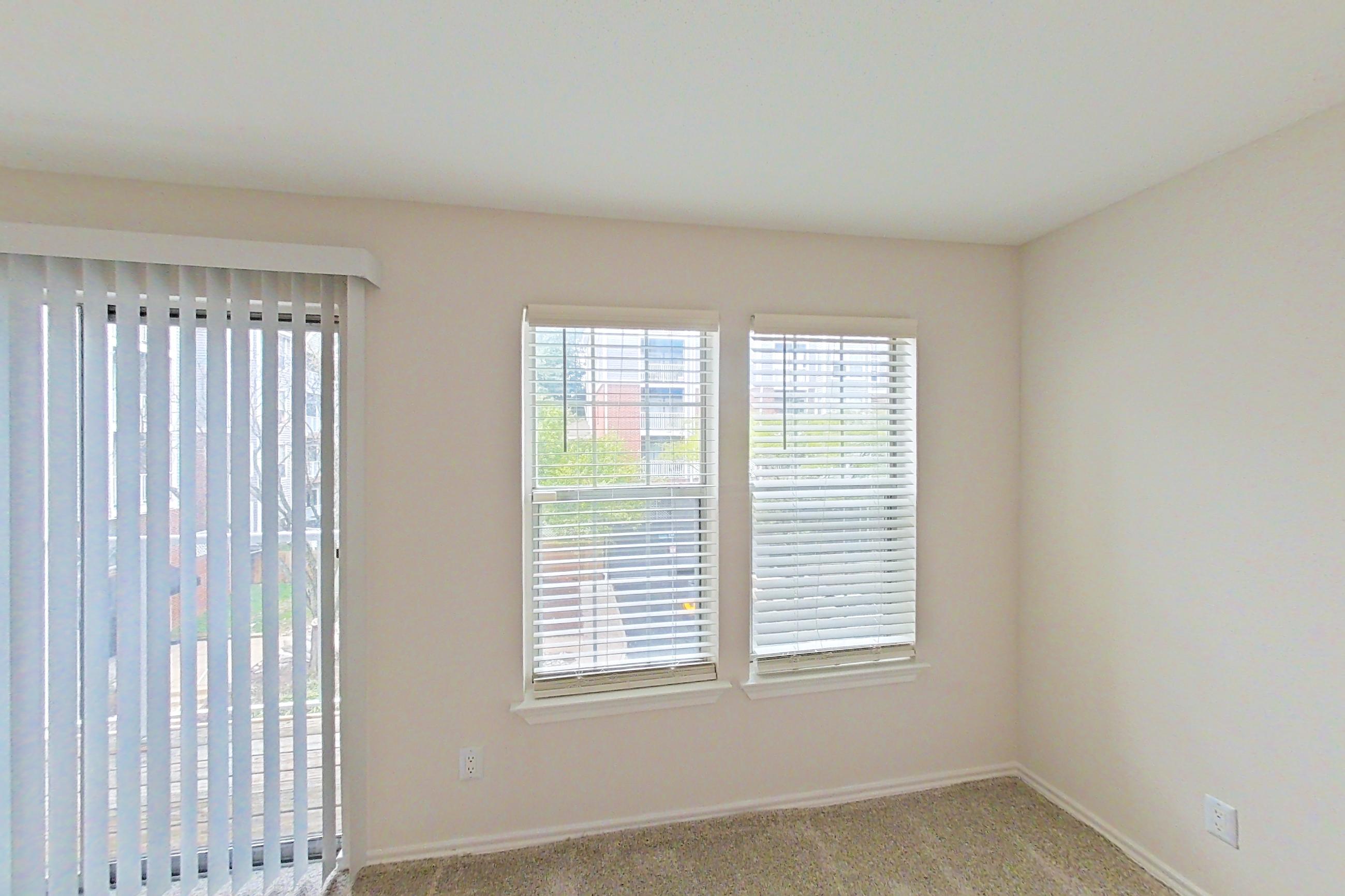 Living room with fireplace, light carpet, and tile fireplace, Apartment 5117 at Cortland Van Dorn
