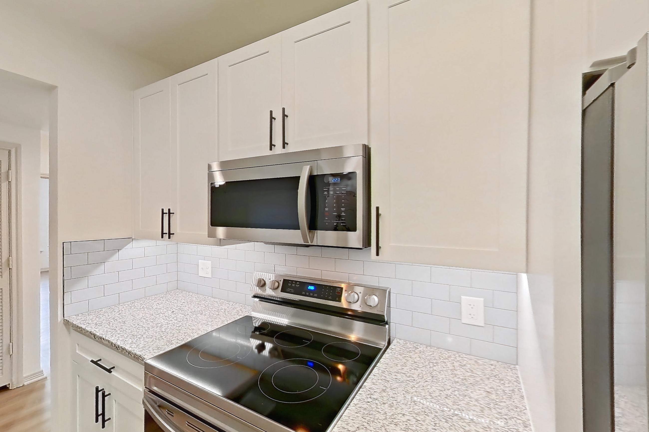 Kitchen in a B1R - Cypress Falls floor plan apartment, representative of Apartment 3307 at Cortland Wortham