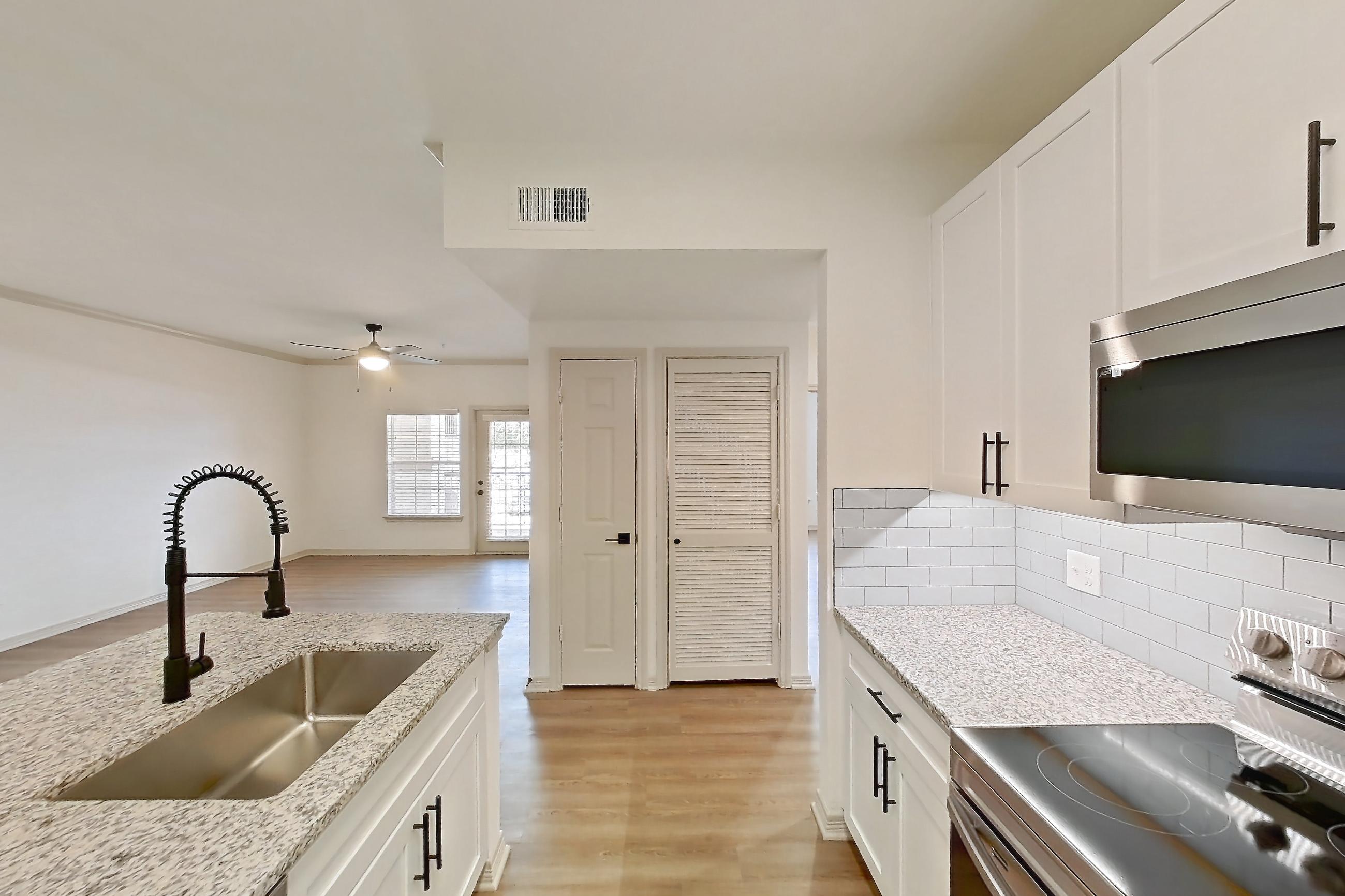 Kitchen in a B1R - Cypress Falls floor plan apartment, representative of Apartment 3307 at Cortland Wortham