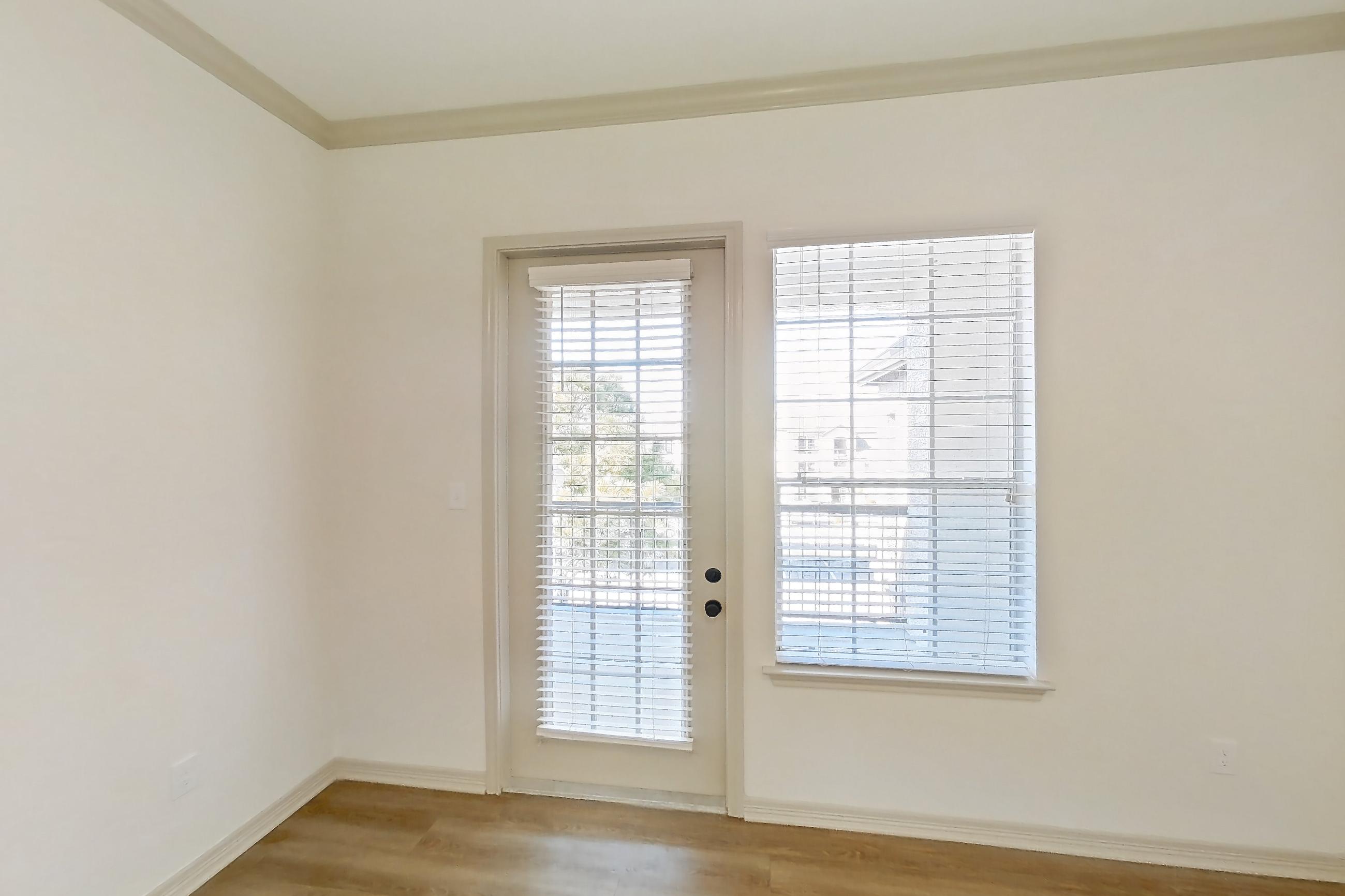 Living room with electric range, light wood-finish flooring, oven/range, and stainless steel appliances, Apartment 8305 at Cortland Wortham
