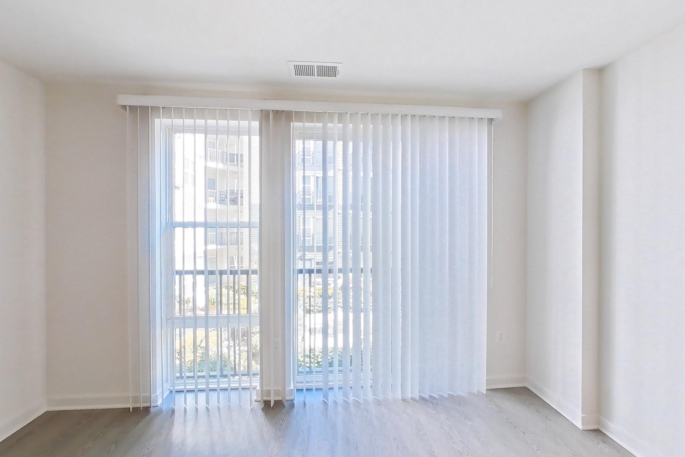 Living room with light wood-finish flooring, Apartment 246 at Cortland Columbia Pike