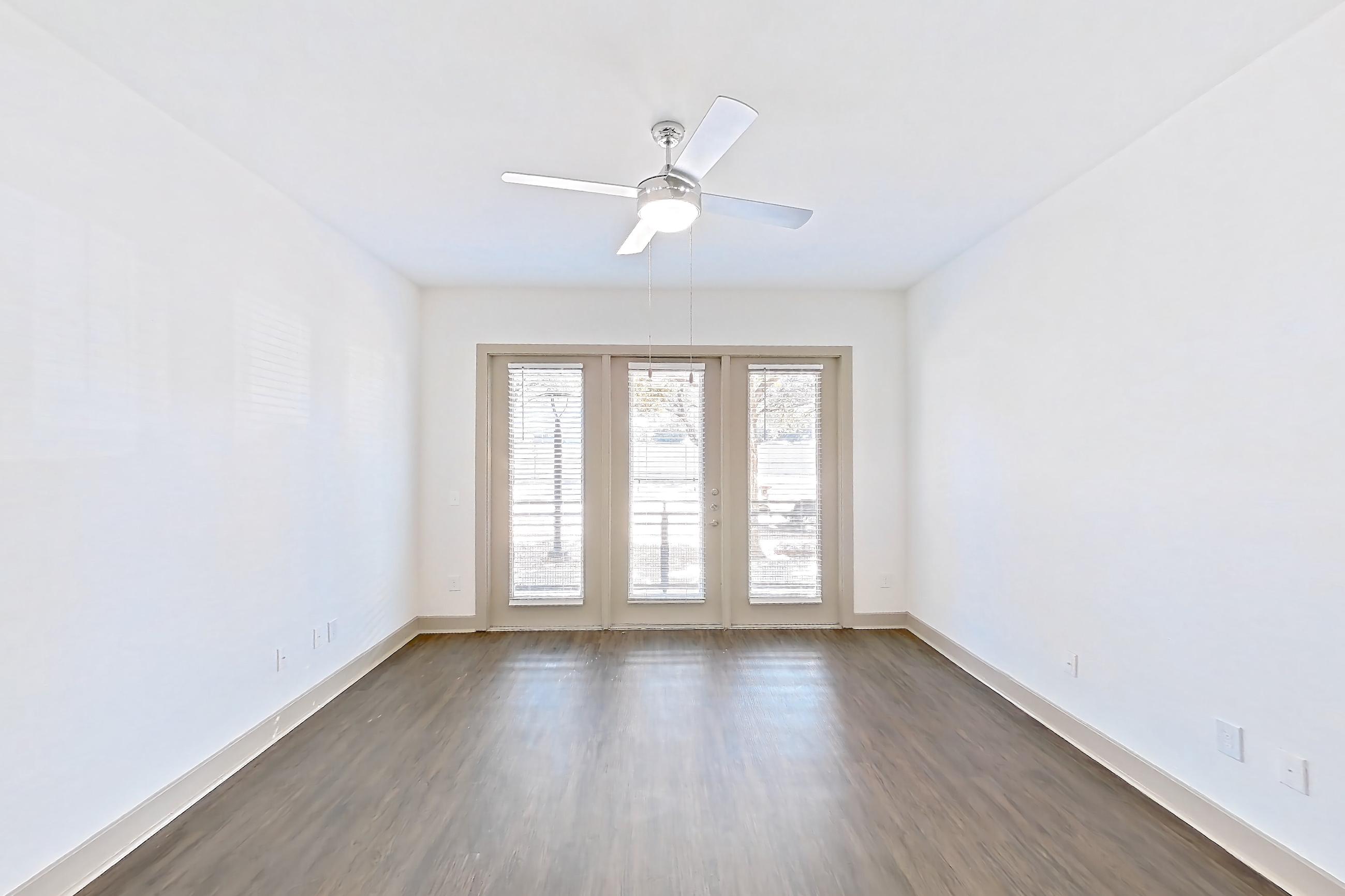 Living room with dark wood-finish flooring, Apartment 3114 at Cortland Galleria