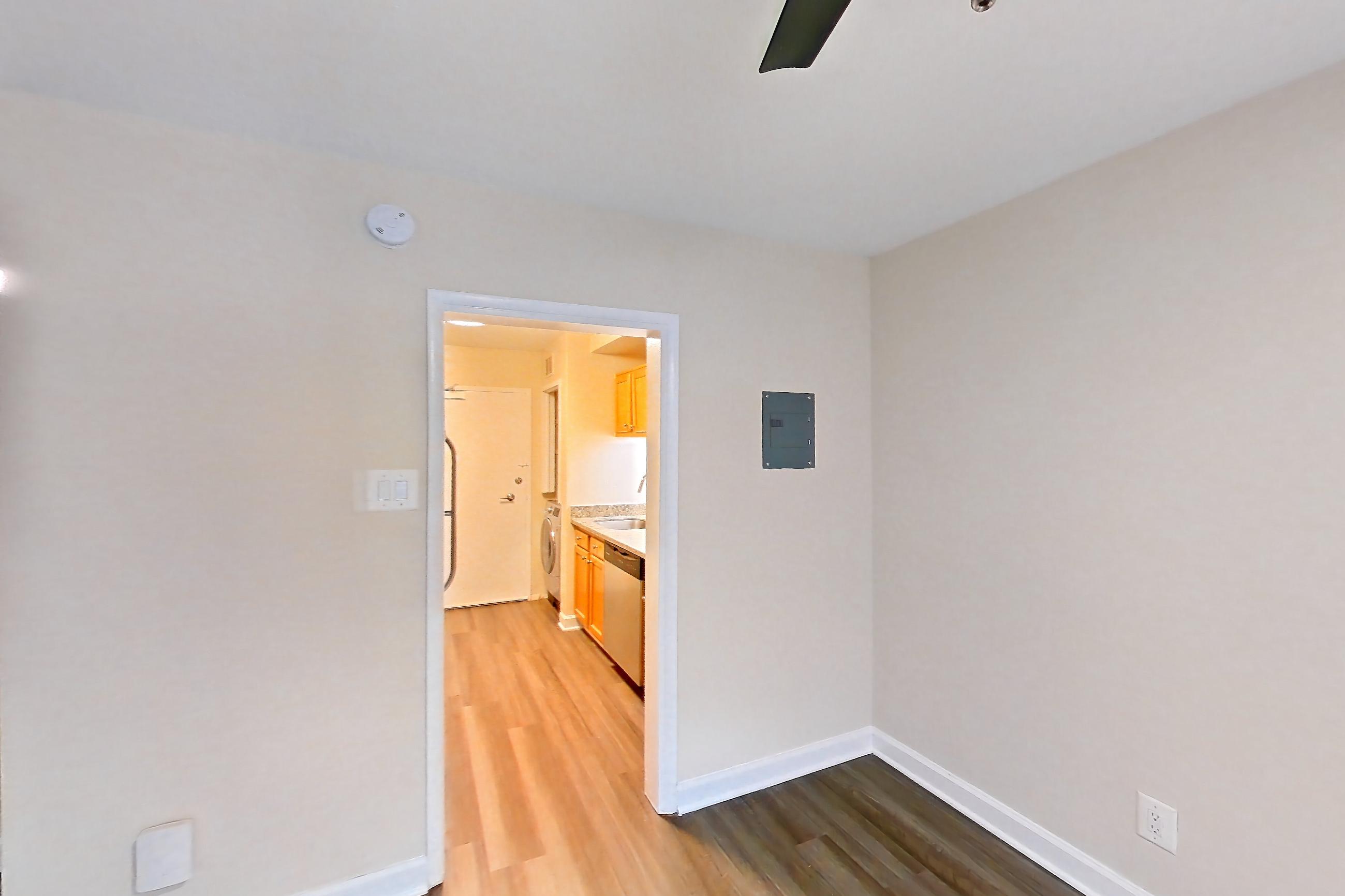 Dining room with dark wood-finish flooring, dishwasher, and stainless steel appliances, Apartment S-129 at Cortland on Pike