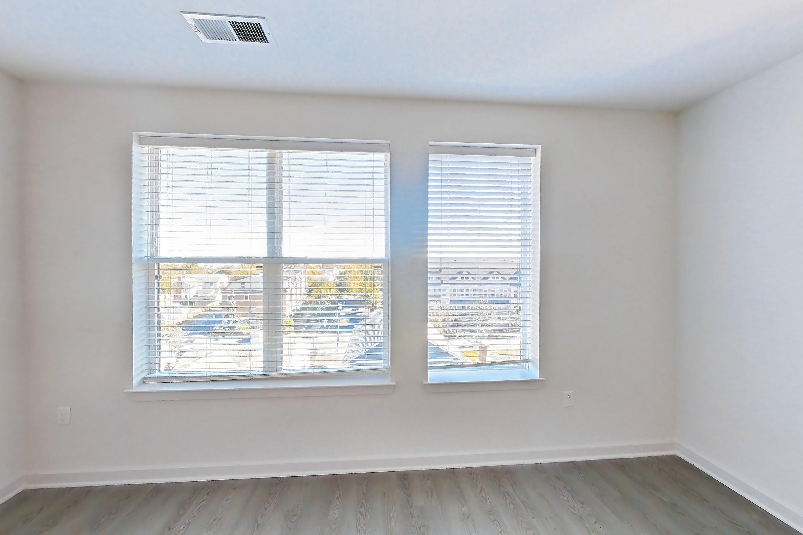 Living room with light wood-finish flooring, Apartment 633S at Cortland Columbia Pike