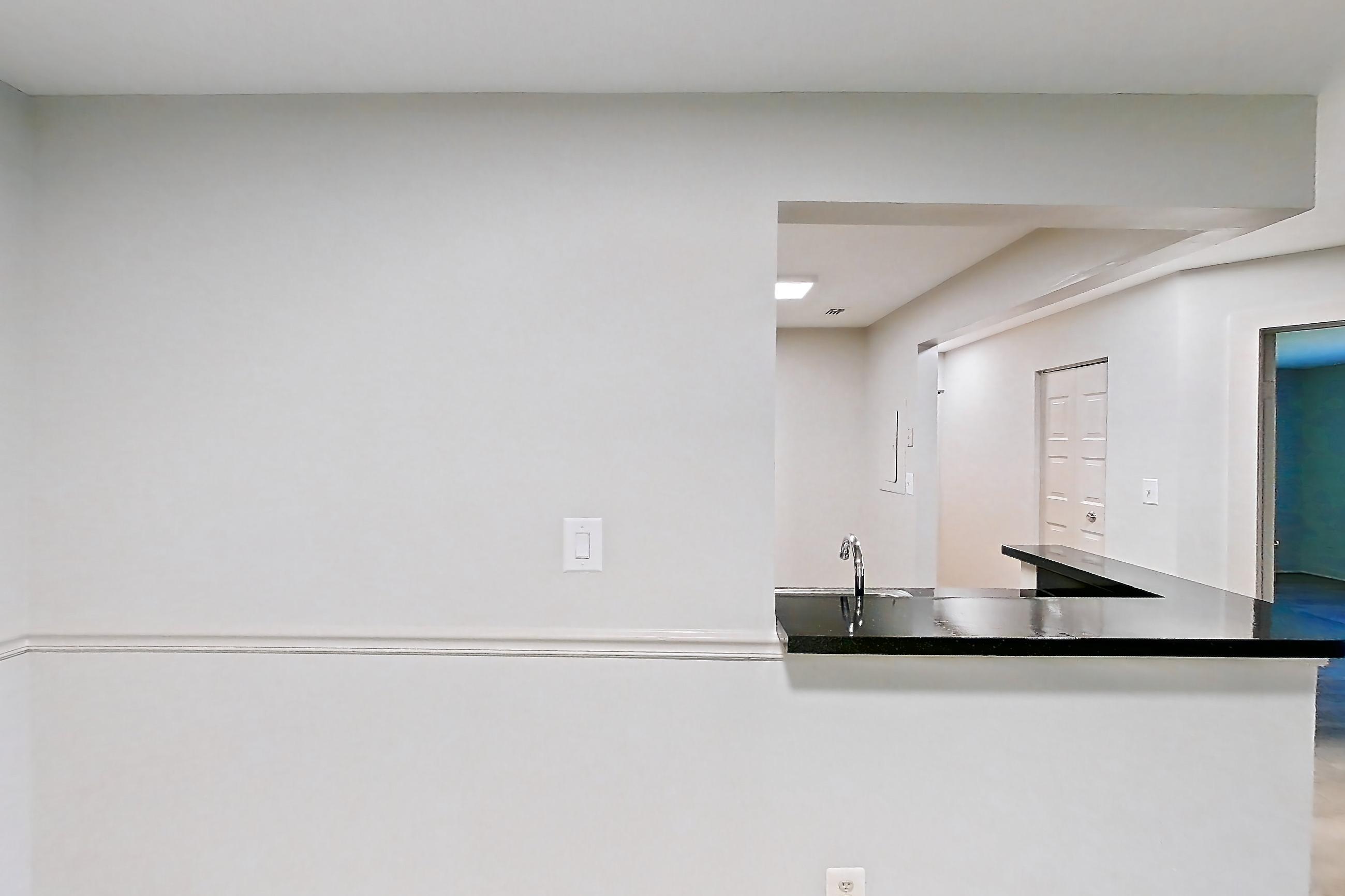 Dining room with dark countertops and light wood-finish flooring, Apartment 5022 at Cortland Manassas