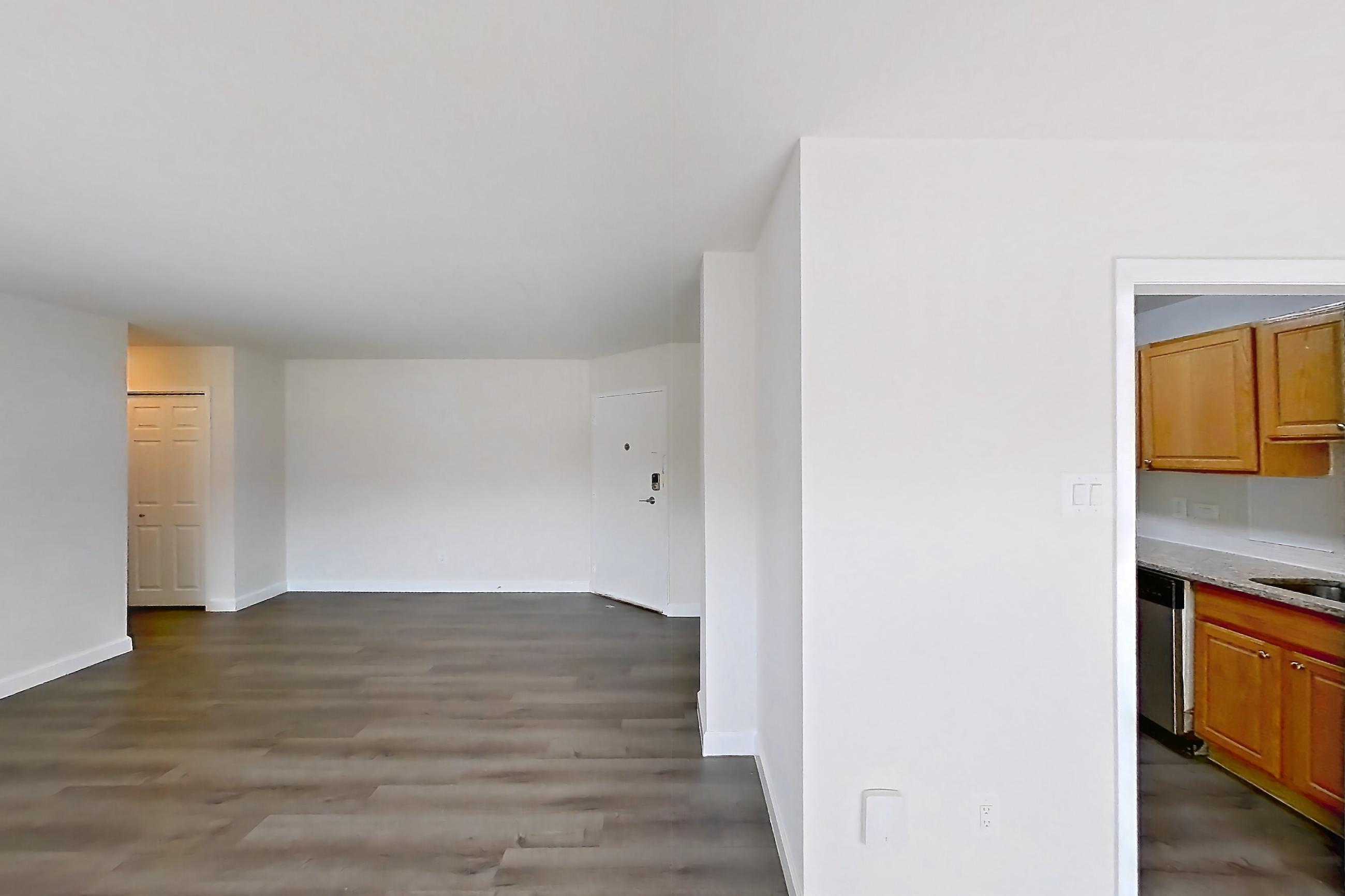 Living room with dark wood-finish flooring, Apartment C-333 at Cortland on Pike