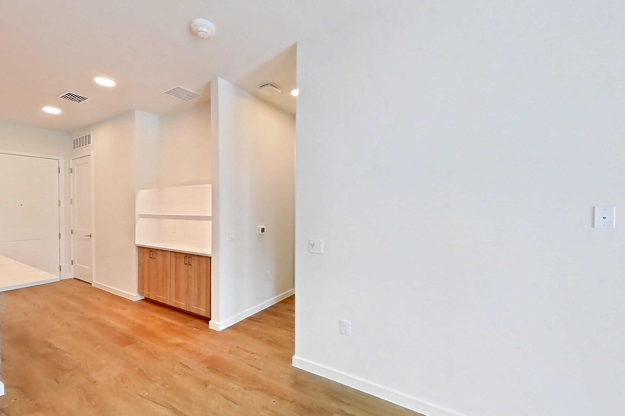 Living space with dishwasher, electric range, light countertops, light wood-finish flooring, oven/range, refrigerator, and stainless steel appliances, Apartment 240 at Lantower Bayside