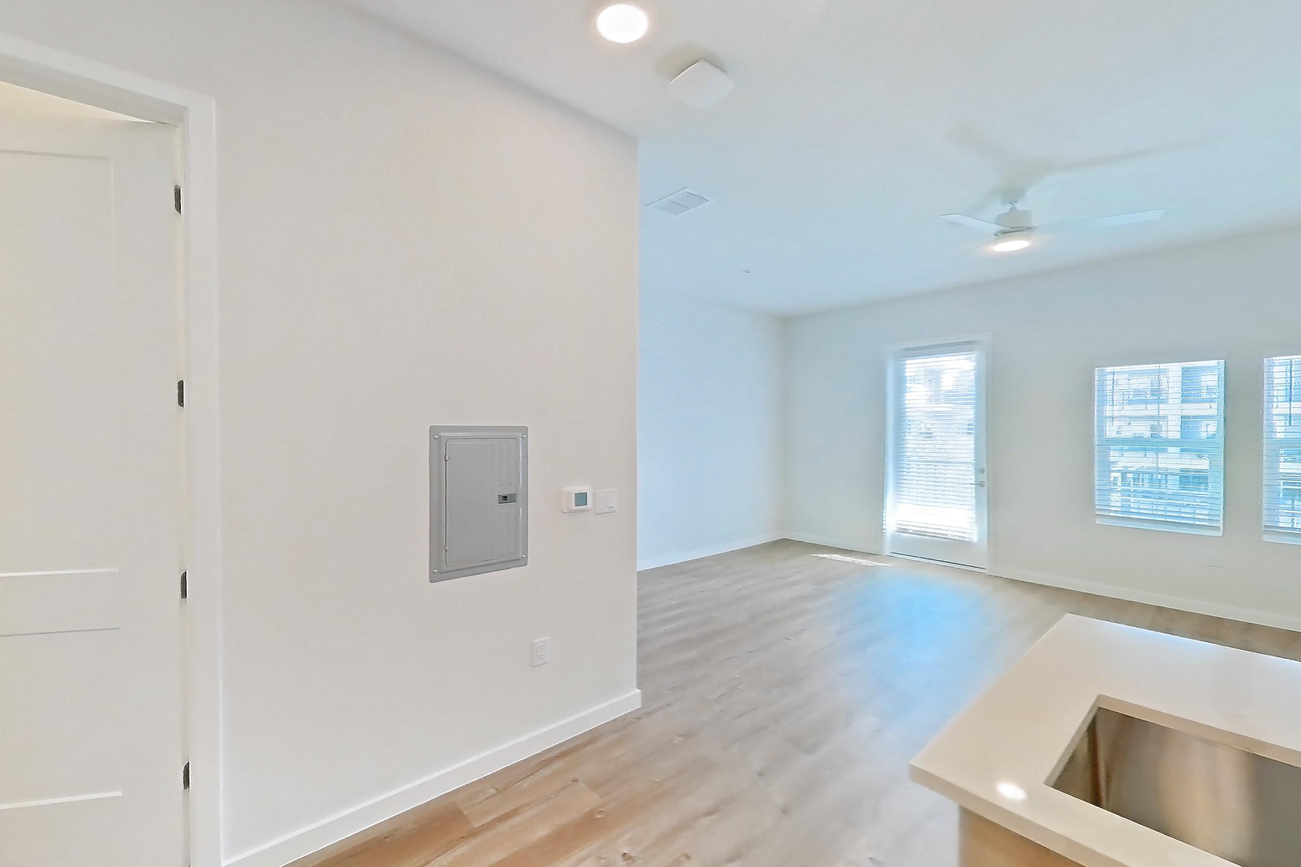 Kitchen with electric range, light countertops, light wood-finish flooring, microwave, oven/range, refrigerator, and stainless steel appliances, Apartment 260 at Lantower Bayside