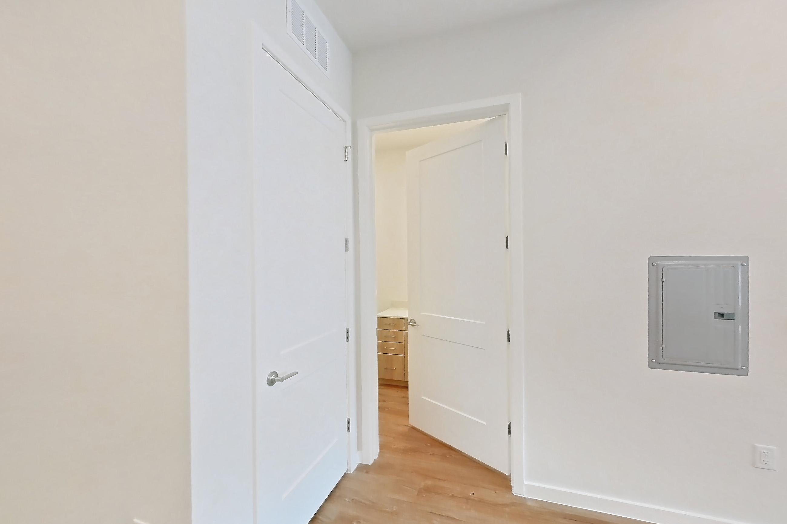 Kitchen with electric range, light countertops, light wood-finish flooring, microwave, oven/range, refrigerator, and stainless steel appliances, Apartment 260 at Lantower Bayside