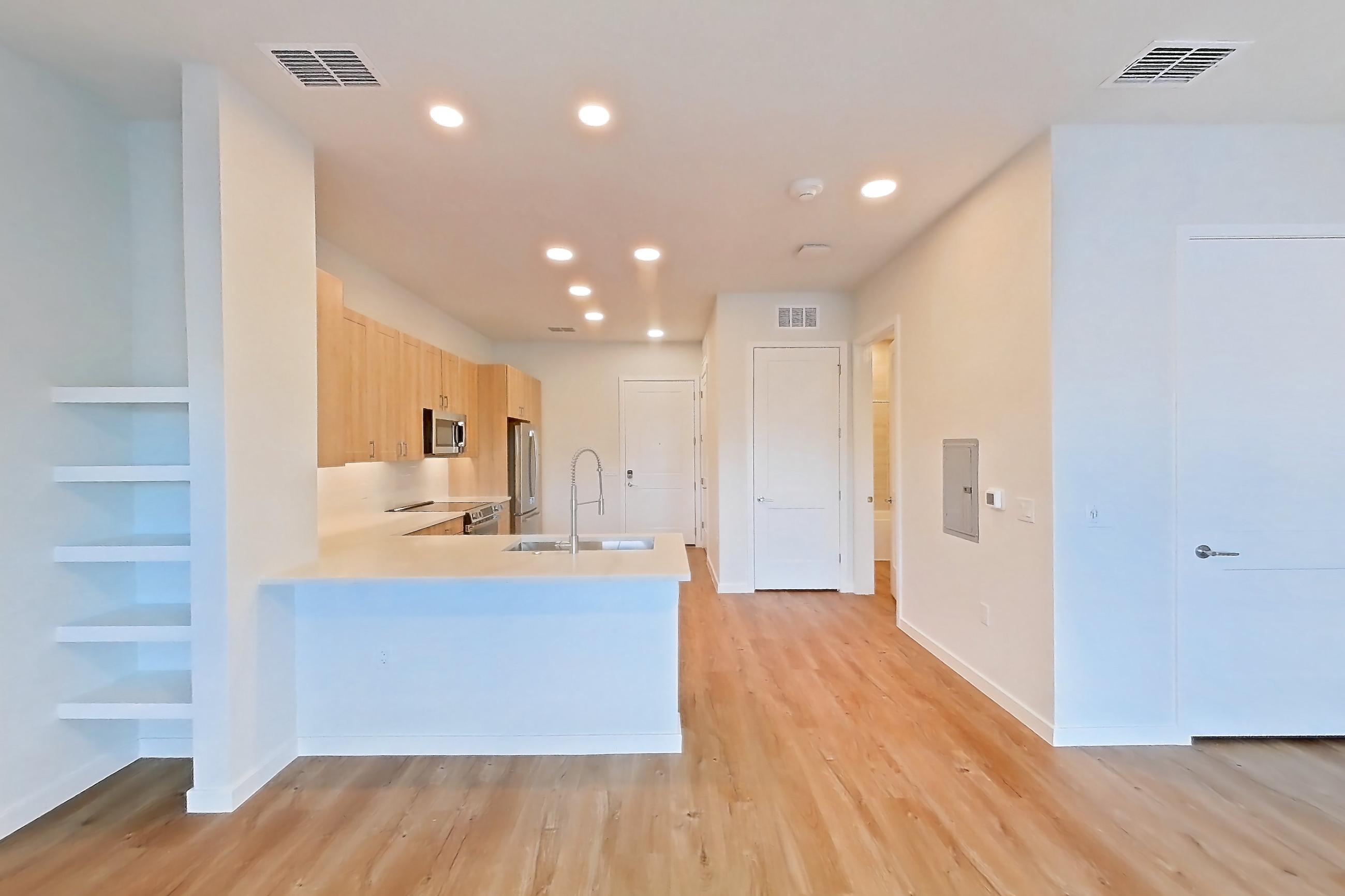 Living space with electric range, light wood-finish flooring, oven/range, refrigerator, and stainless steel appliances, Apartment 470 at Lantower Bayside