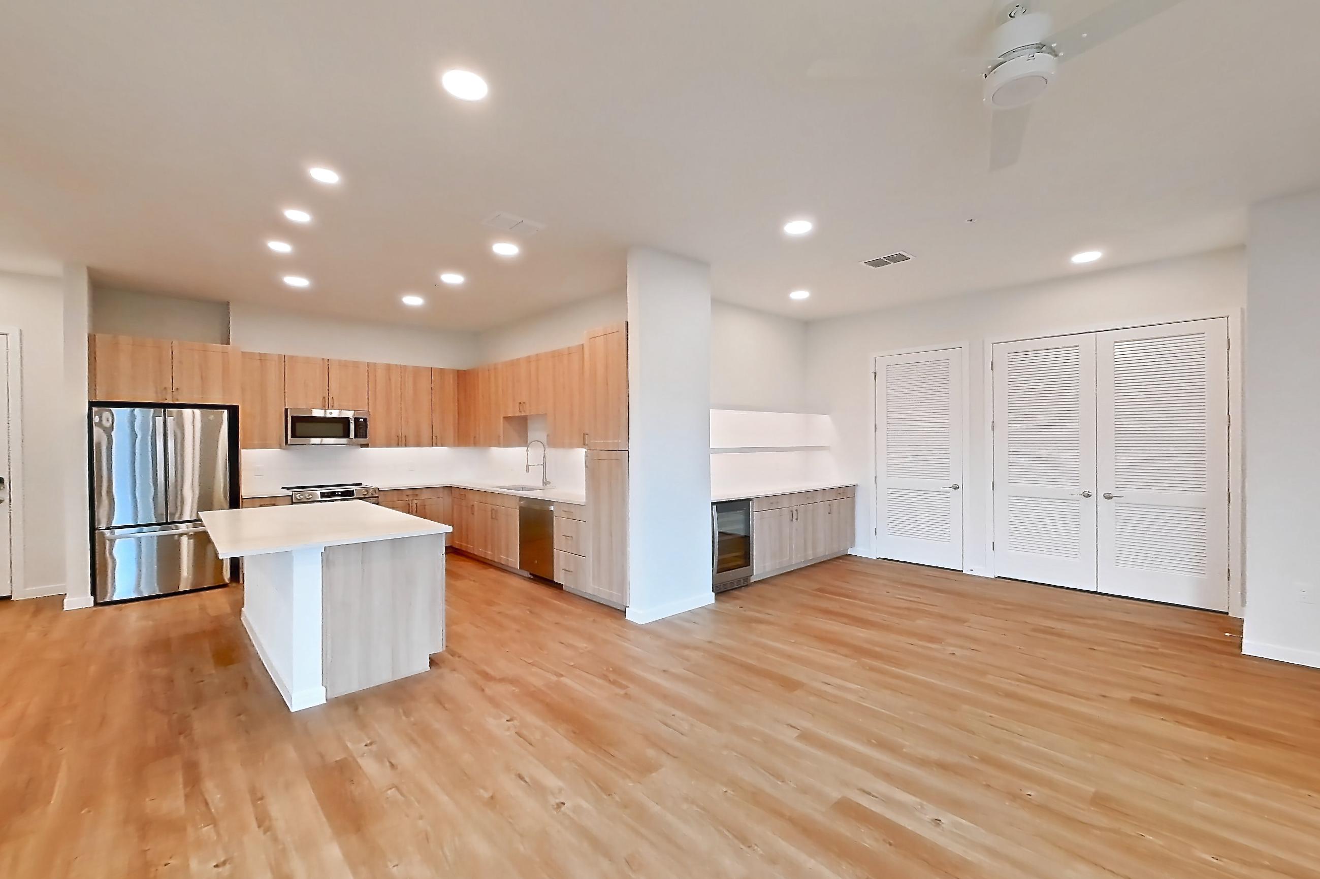 Living space with dishwasher, electric range, light countertops, light wood-finish flooring, oven/range, and stainless steel appliances, Apartment 474 at Lantower Bayside