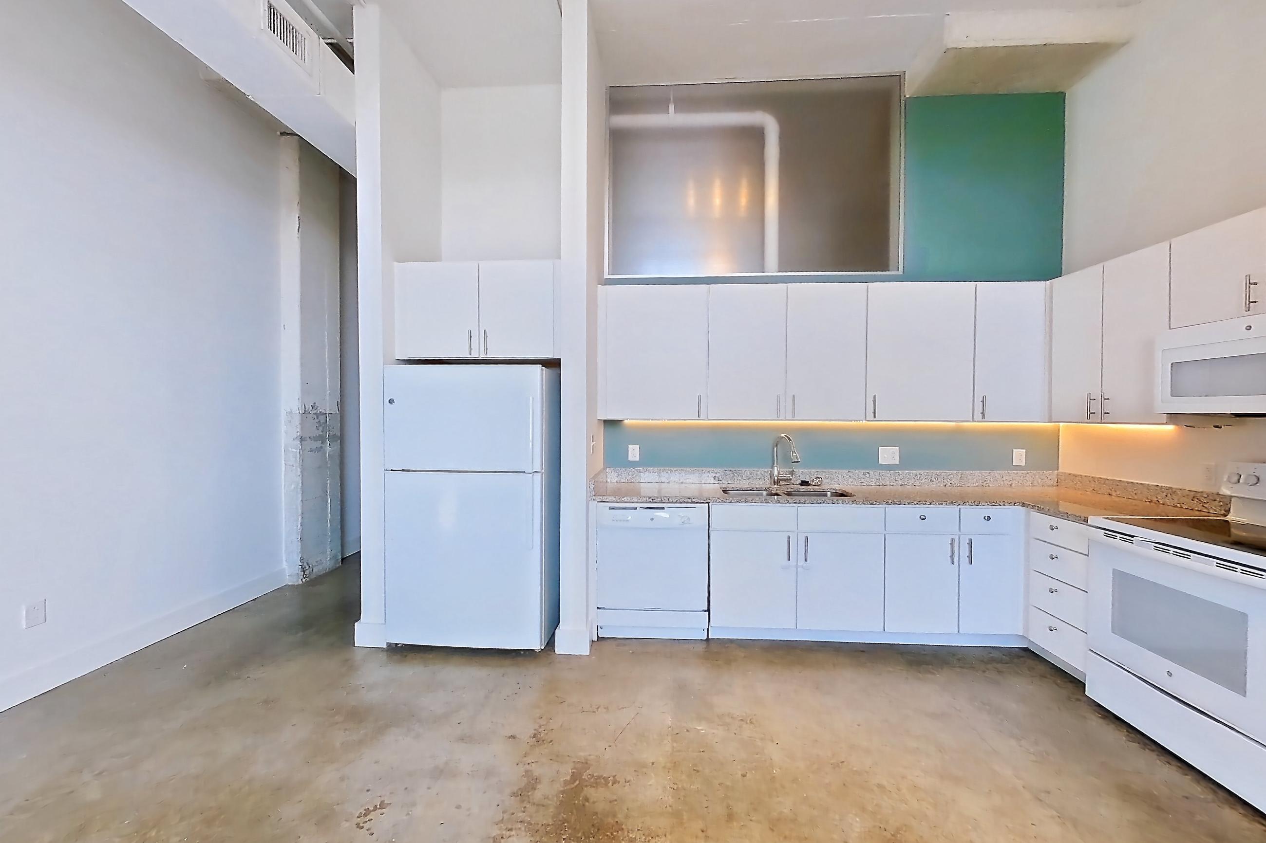 Living space with concrete flooring, dishwasher, electric range, light concrete flooring, light countertops, light stone countertops, oven/range, refrigerator, and white appliances, Apartment 1013 at Parcels at Concourse