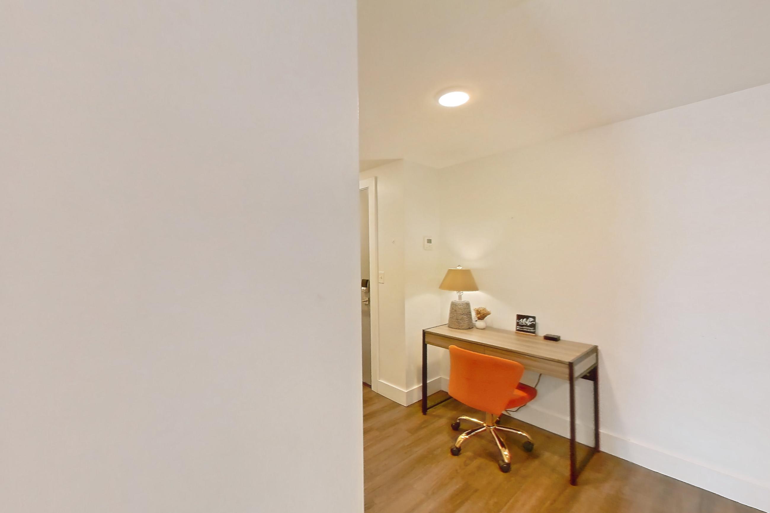 Living space with light wood-finish flooring, refrigerator, and white appliances, Apartment 1-415 at Netherland and Monarch